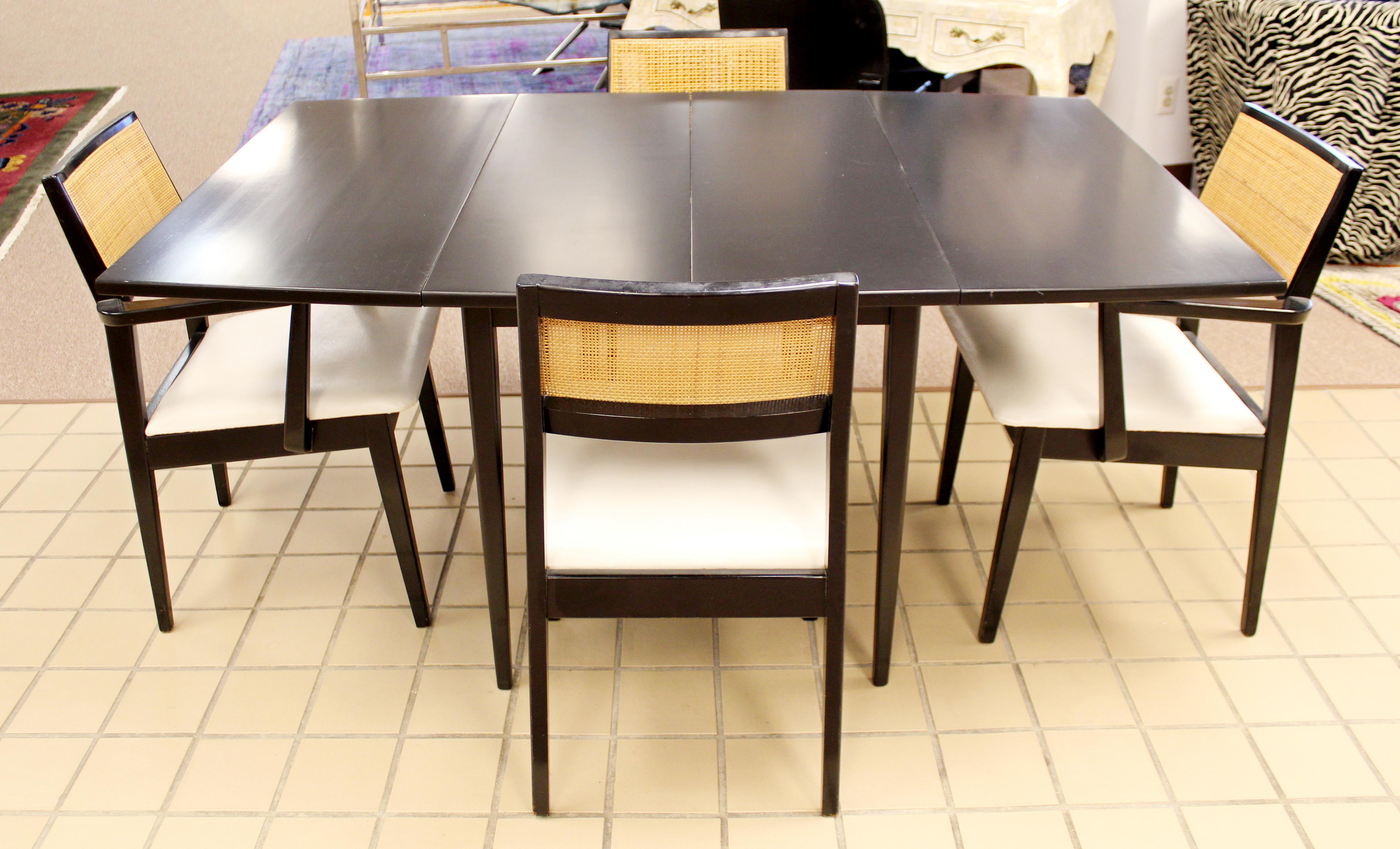 For your consideration is a wonderful dining or dinette set, including two side and two armchairs, and a rectangular table with three leaves, circa 1960s. In very good vintage condition. The dimensions of the table are 36