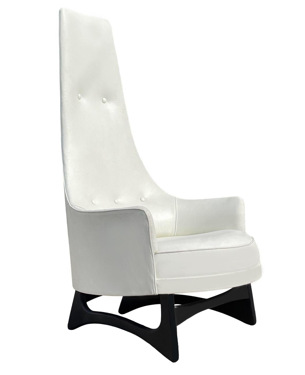 A tall sculptural lounge chair designed by Adrian Pearsall in the 1960's. It features the original white naugahyde fabric with ebony legs.