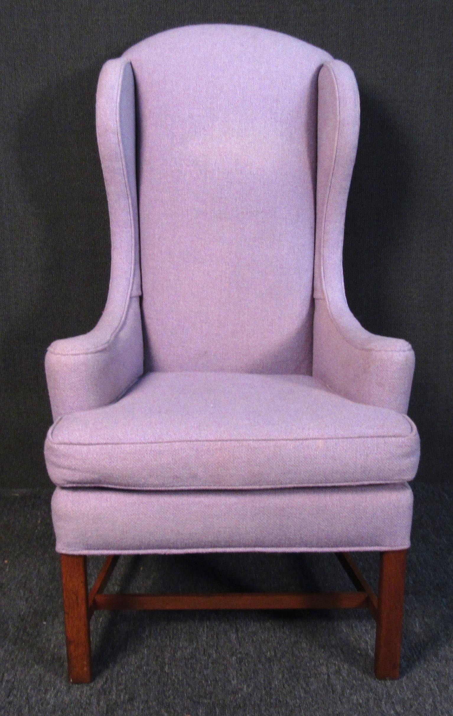 Classic vintage modern wingback/ high back style lounge chair. The chair is upholstered in a light purple fabric. The wingback chair is an icon of mid-century design and is the perfect lounge chair to kick back and read a book or have your morning