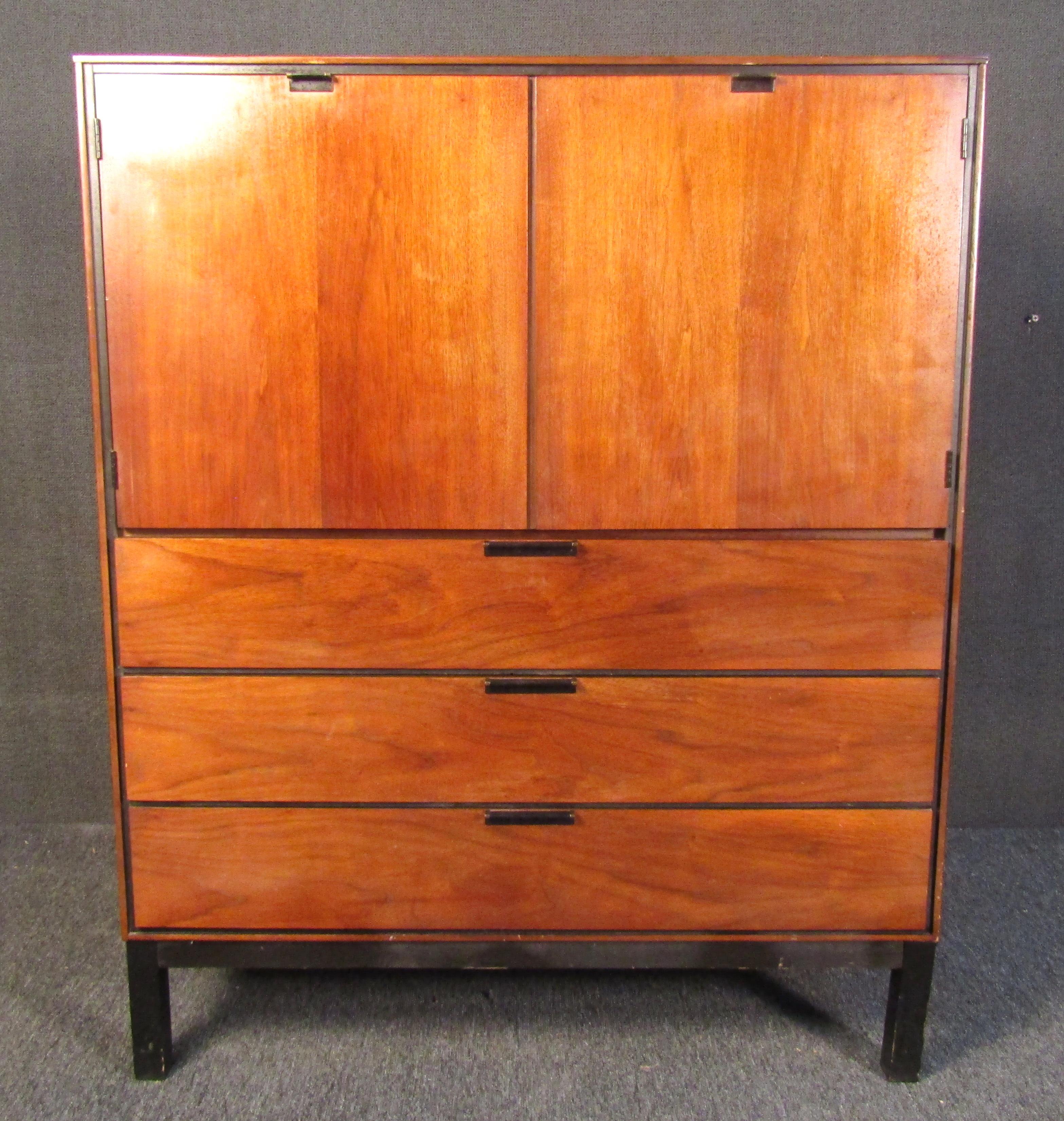 Beautiful vintage modern high boy dresser. Equipped with six spacious drawers, three on the bottom, and three hidden behind the two beautiful cabinet doors on top. The bottom drawer of the cabinet features dividers for easier organization. This
