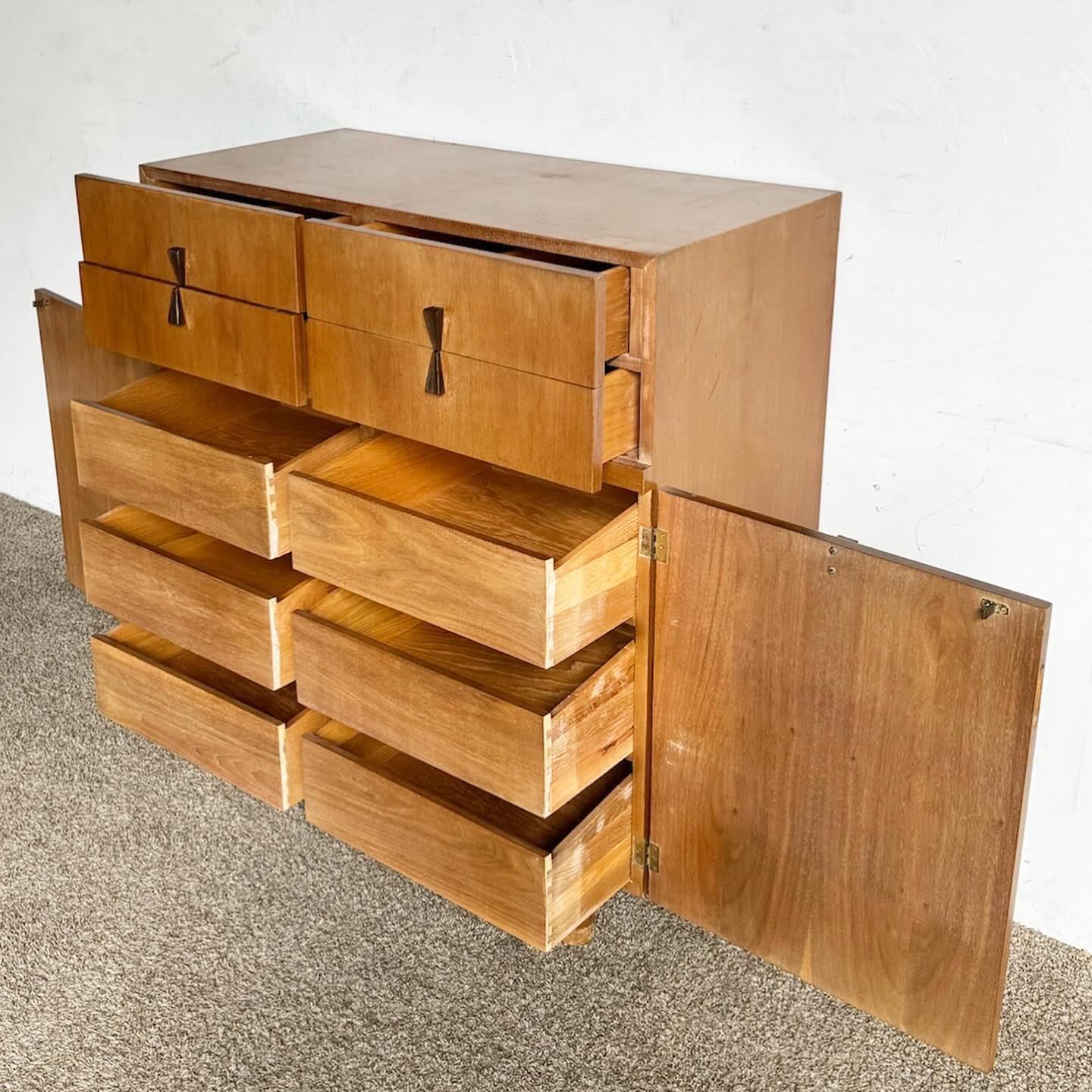 The Mid Century Modern Highboy Dresser by American of Martinsville is a perfect addition to any home, blending sleek design with functional storage. This tall dresser features clean lines and a streamlined profile, offering ample space in a compact