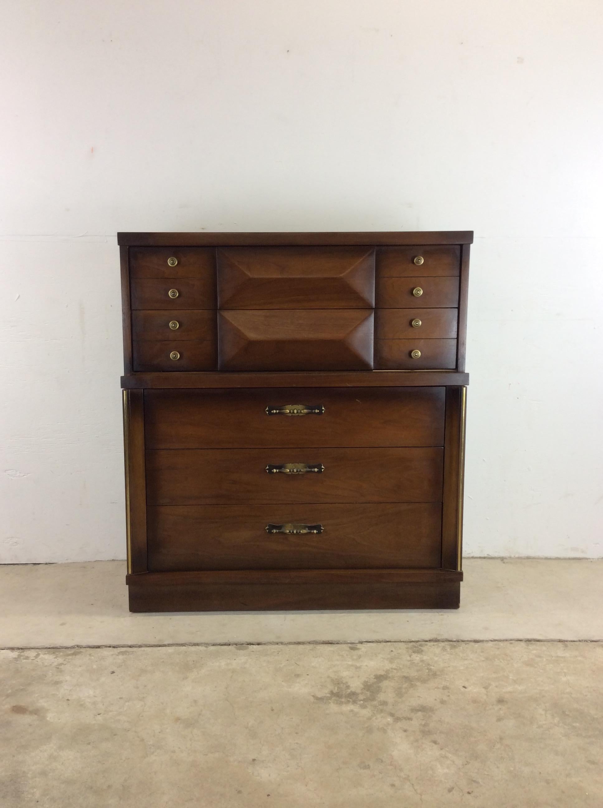 This Midcentury highboy dresser features hardwood construction, walnut veneer with original finish, five dovetailed drawers with original brass accented hardware, top two drawers feature beveled center detailing. ??Matching pair of nightstands,