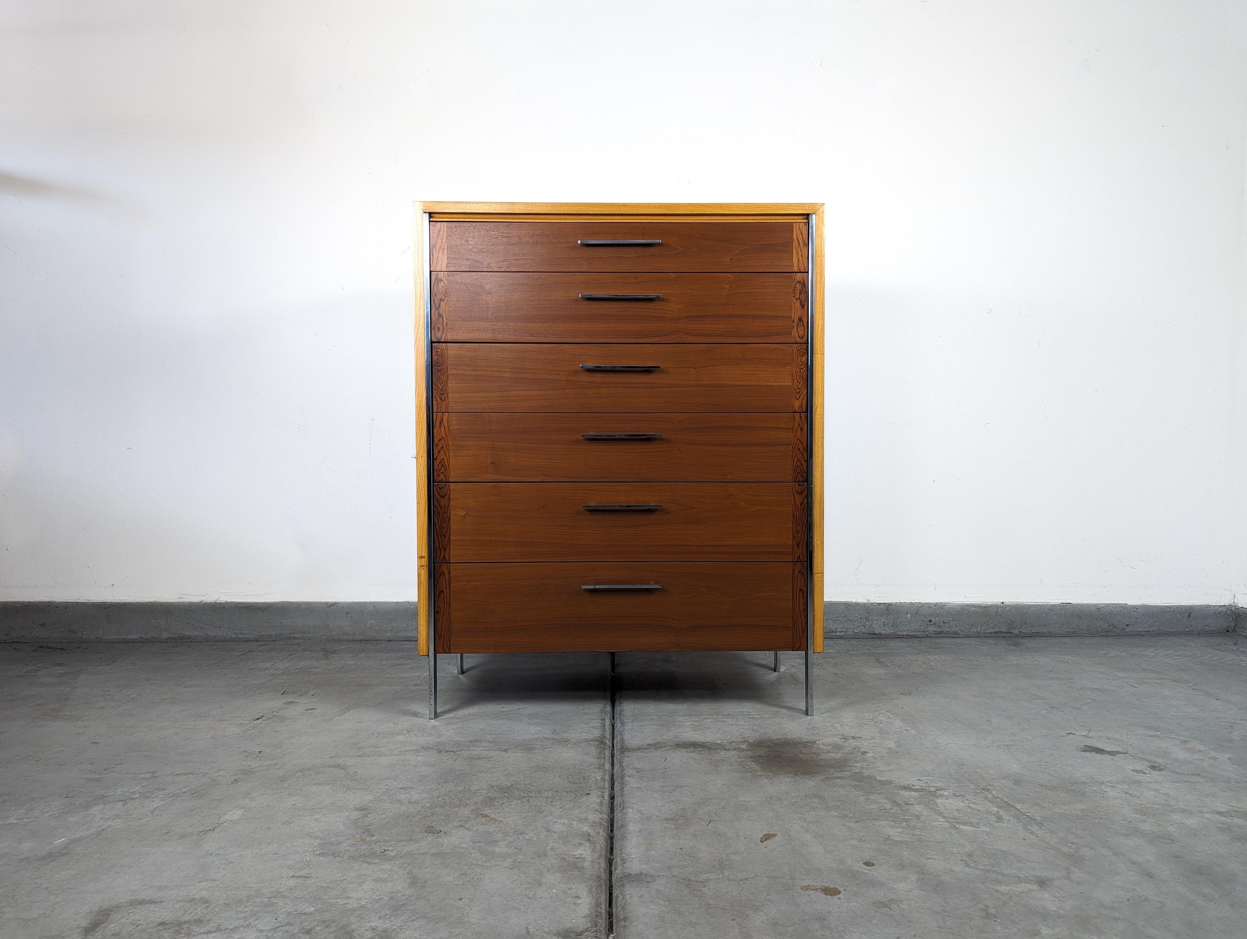Elevate your interior with this exquisite mid-century modern highboy dresser by the esteemed Lane Furniture, circa 1960s. Renowned for its sophisticated design, this piece showcases the timeless allure of walnut and oak, creating a striking contrast