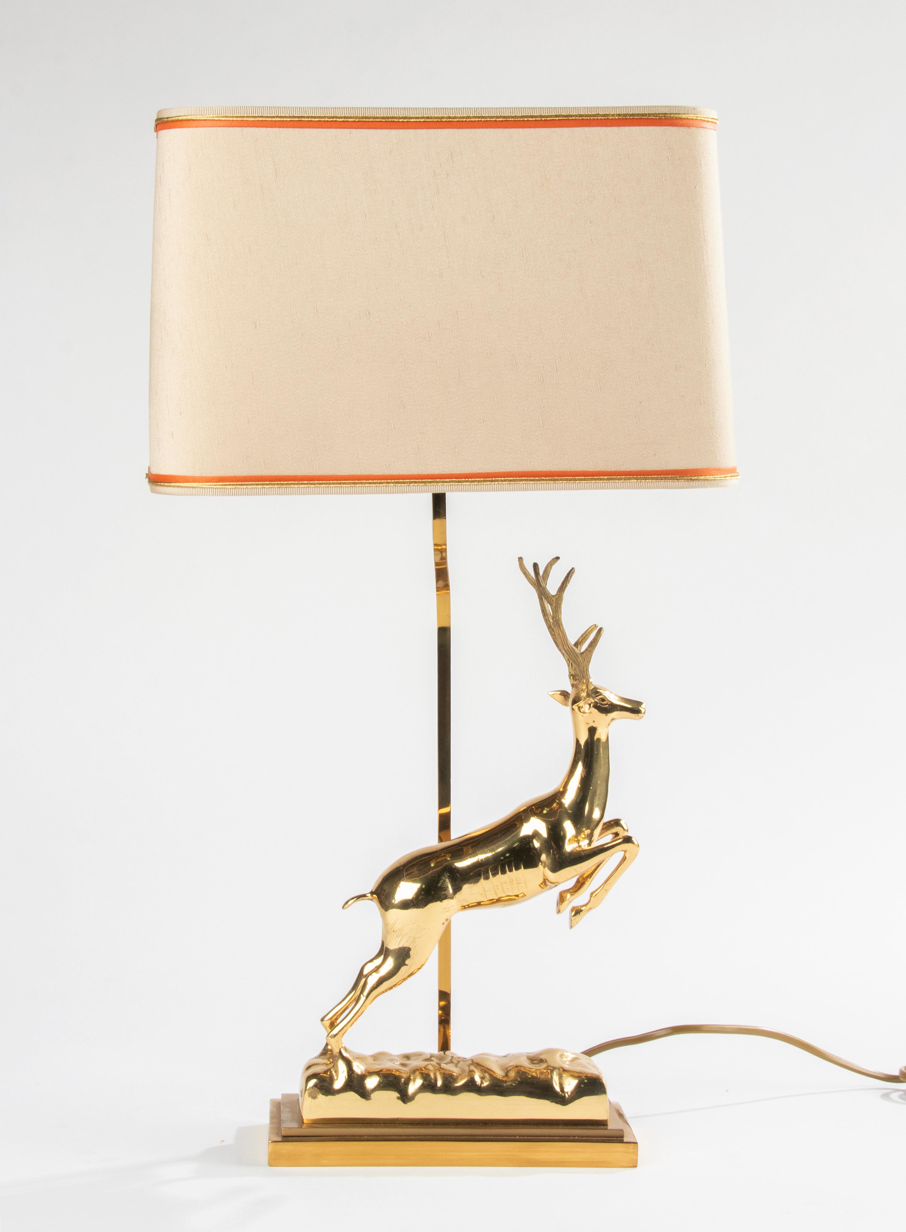 Beautiful Hollywood Regency table lamp, with a stylized sculpture of a deer. 
The lamp dates from circa 1960-1970. On the bottom there is a label 'J.L.B.', this is probably a Belgian maker, but there is not much information about this manufacturer