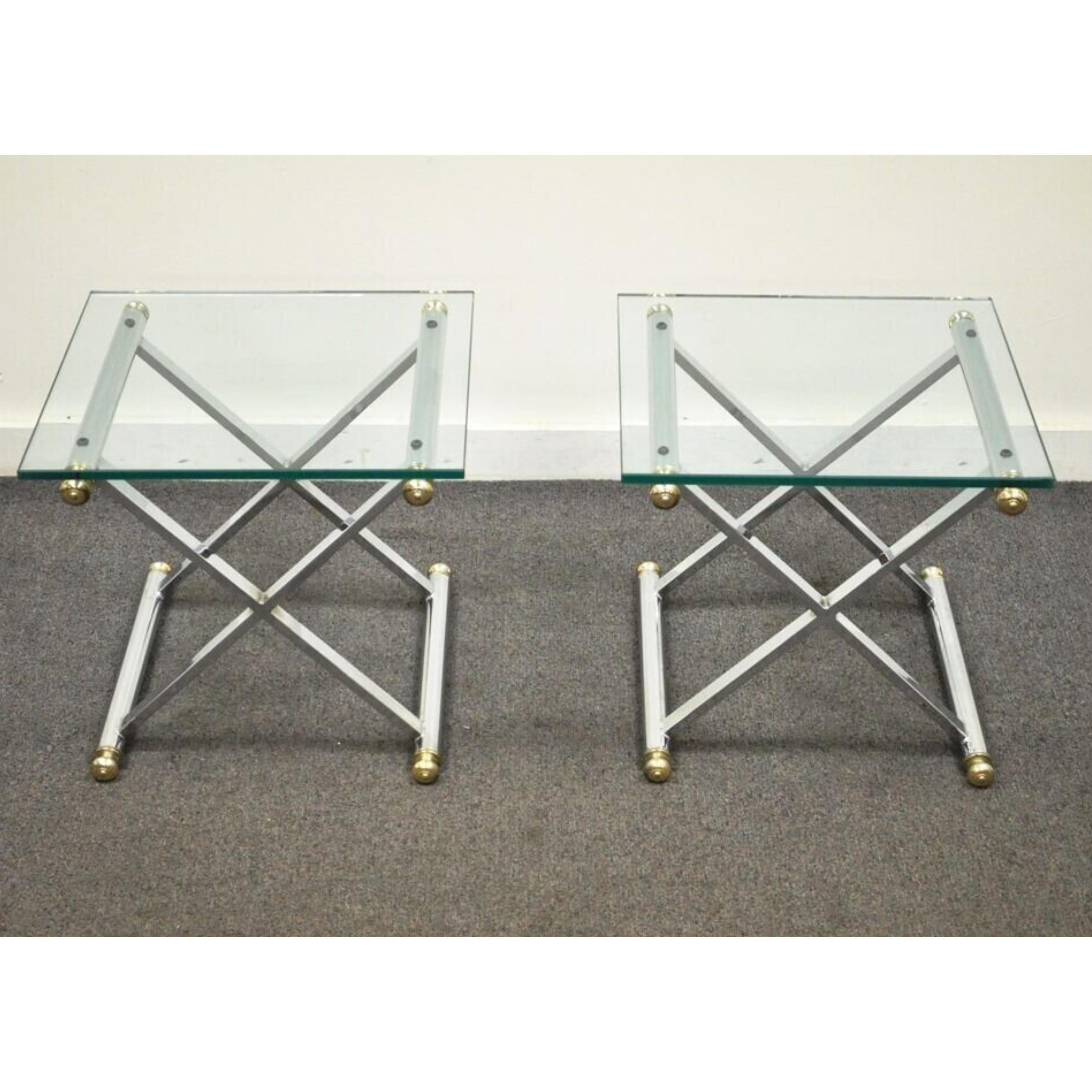 Mid Century Modern Hollywood Regency Chrome Brass Glass X Form Side Tables - a Pair. Item features  an X-form stretcher base, thick glass, very nice vintage item.  Circa Mid to Late 20th Century. Measurements: 15.75