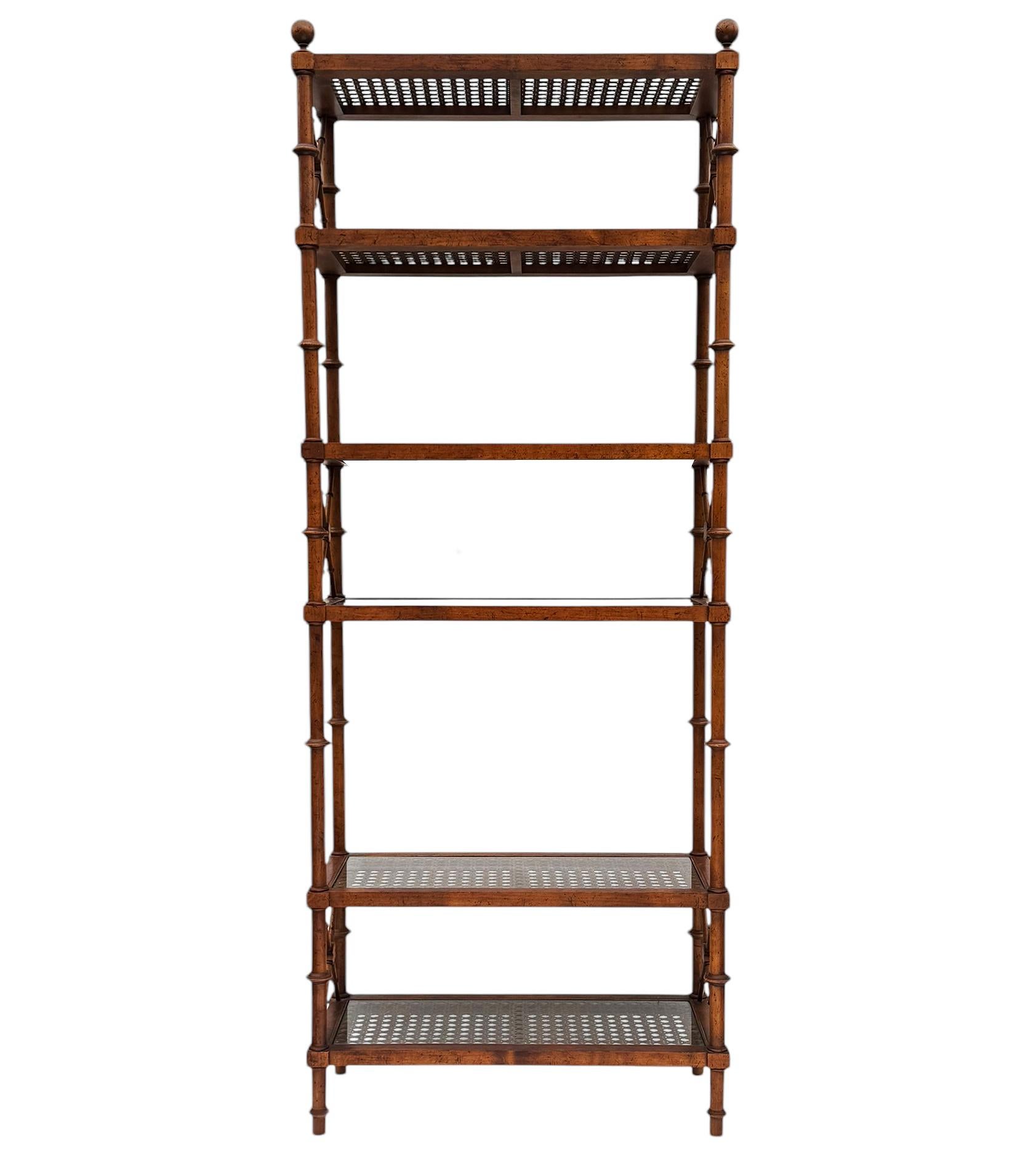 A lovely campaign style étagère with faux bamboo details. It features solid wood construction and multiple caned shelves with inlayed glass. Very good ready to use condition. 
