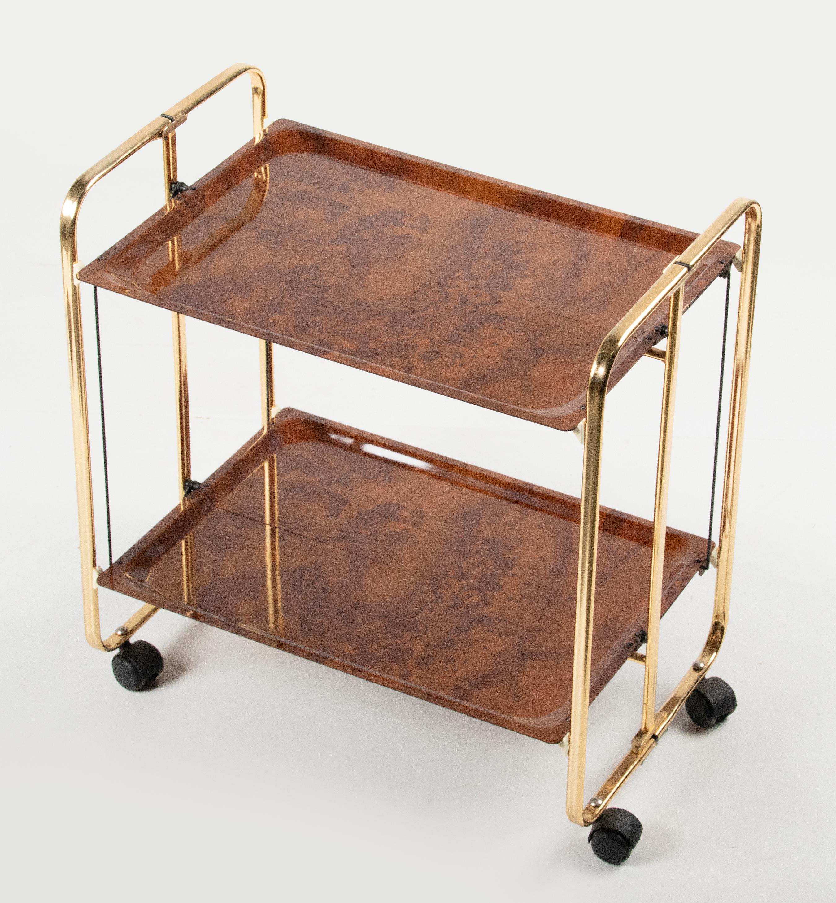 A vintage multifunctional French formica and polished brass folding serving cart. Made in France, 1970-1975. The trays are made of formica in imitation burl walnut. 
In good condition.
Dimensions: 70 x 66 x 40 cm.