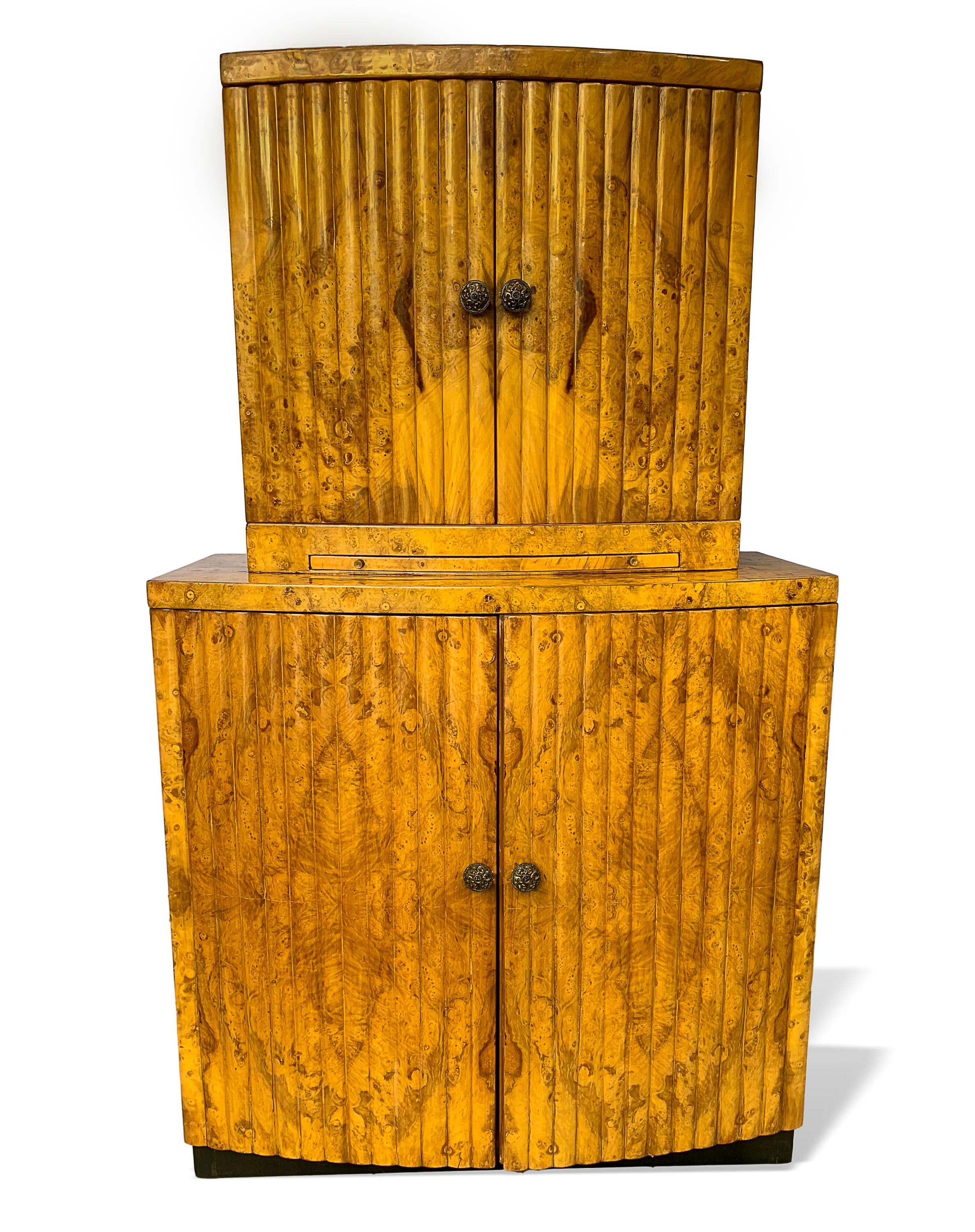 Mid-Century Modern Hollywood Regency liquor cabinet, French, circa 1930, with exotic burl walnut,
channel design. Best example of Art Deco streamline moderne. Freshly pololished and ready for the finest interiors or showroom.
  