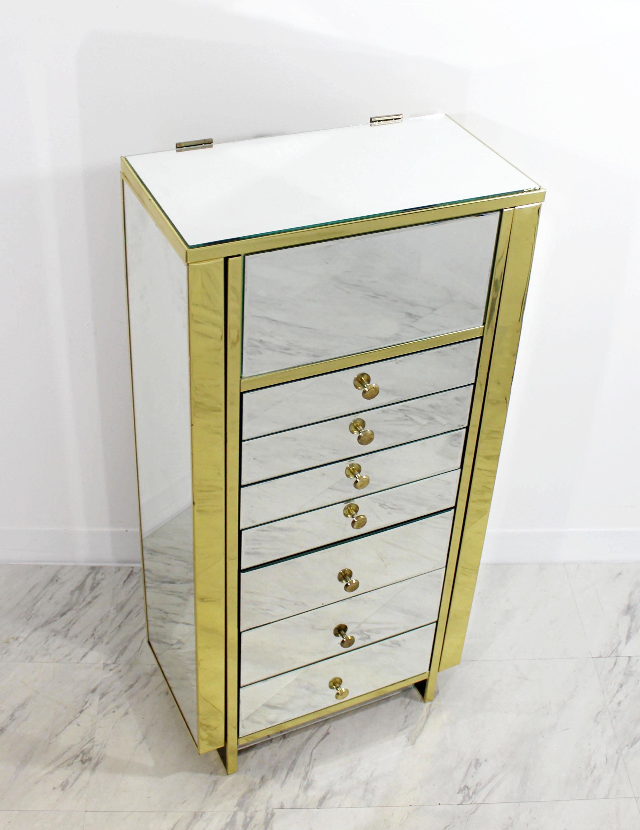 For your consideration is an absolutely fabulous, mirrored armoire or jewelry case, with brass borders and pulls, circa 1970s. In excellent condition, with just a couple nicks in the mirror. The dimensions are 19.5