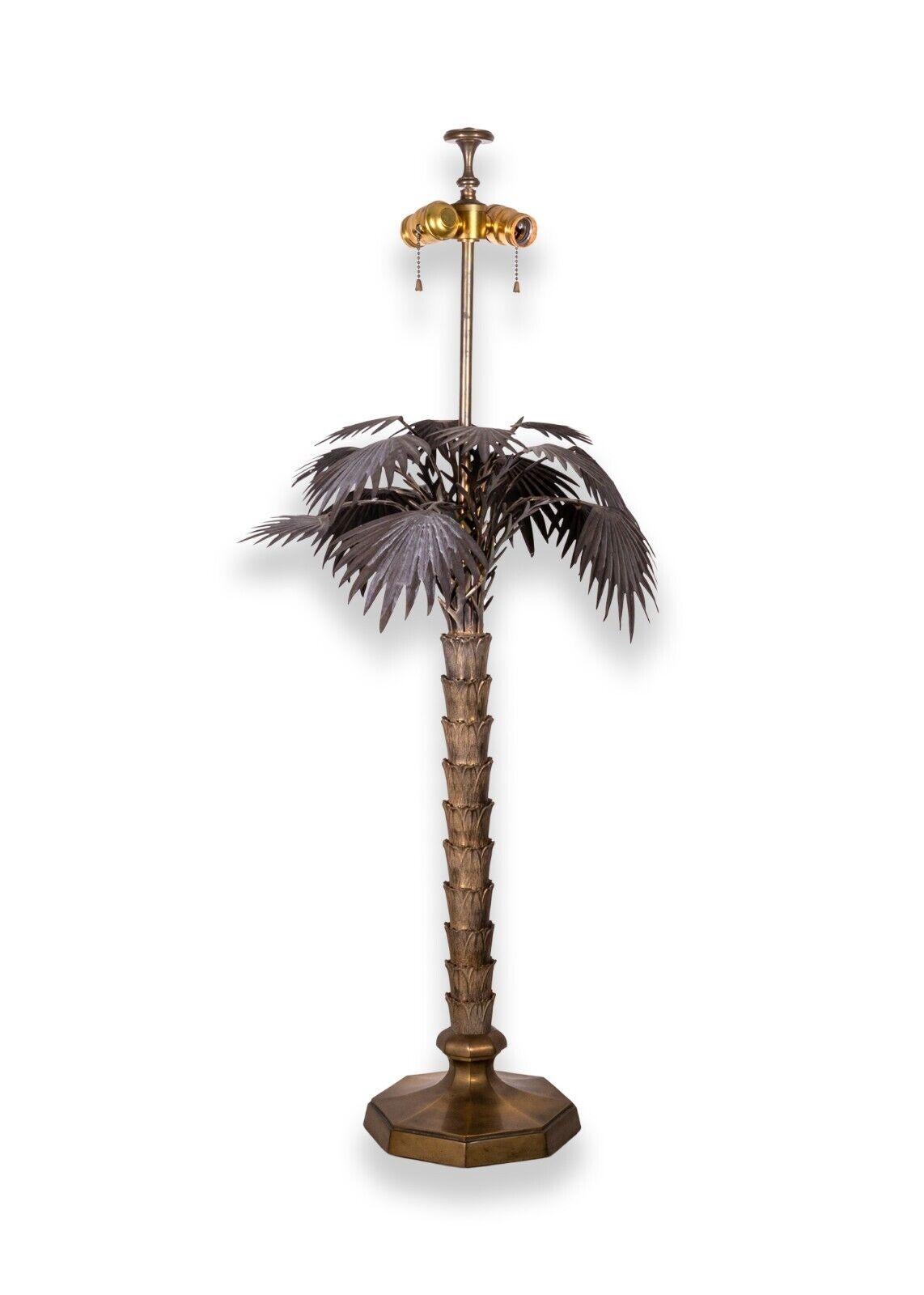 A mid century modern pair of vintage bronze palm tree table lamps. A lovely pair of bronze lamps that resemble palm trees. These two lamps feature a very sculptural design with intricate details as you take a closer look. These pieces are in very