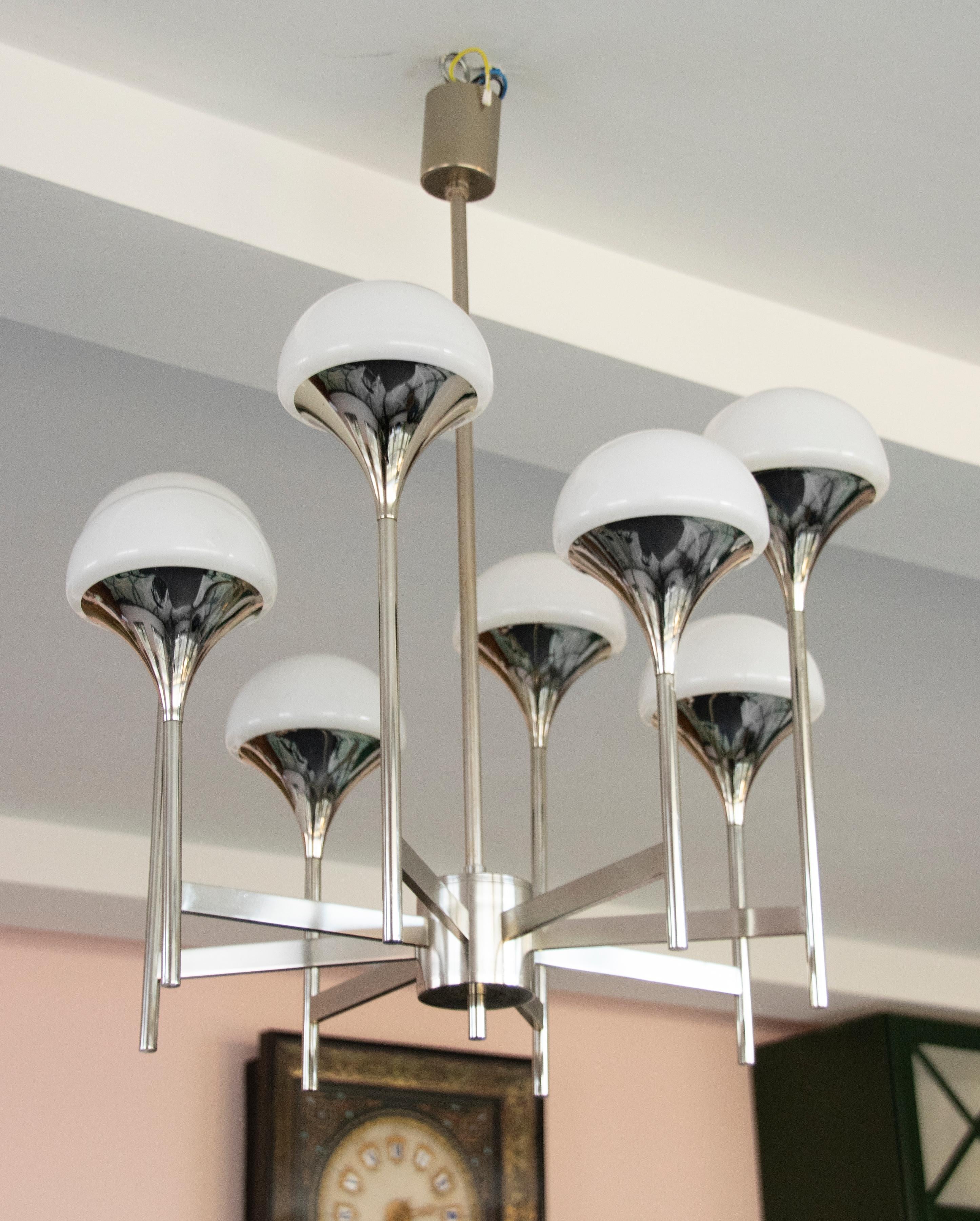 A Sciolari trumpet-shaped chandelier made from chromed metal (iron and brass), with white opal glass globes. The design is made by Gaetano Sciolarie, Italy. The manufacturer is Société Anonyme Boulanger, Belgium. The chandelier have 8 bulbs, E14