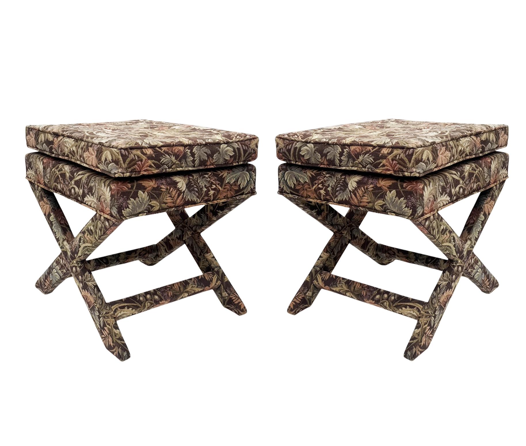 A nice matching pair of upholstered stools in the manner of Bill Baldwin. They feature well made solid wood construction with original upholstery. Price includes the pair.