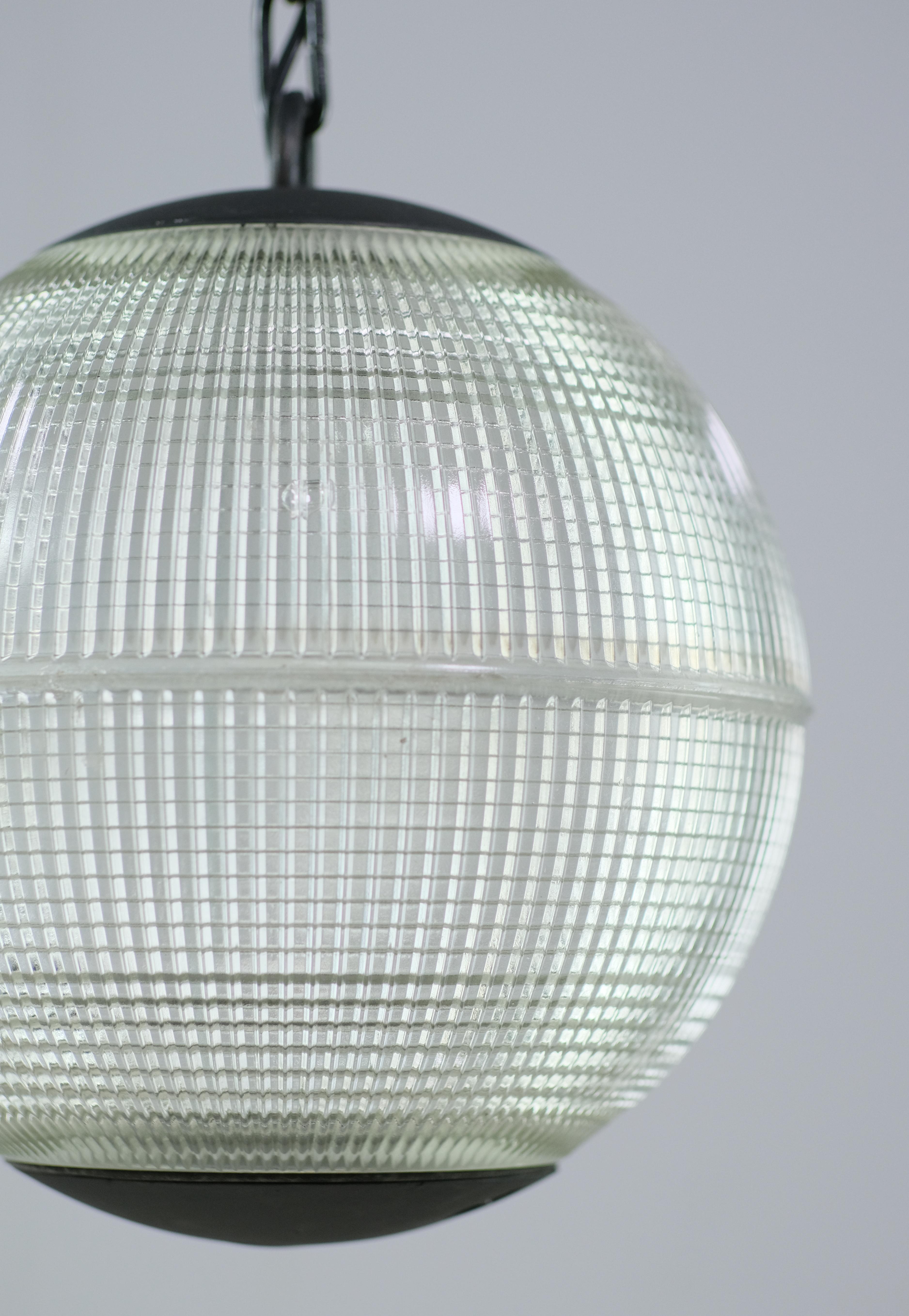 1960s Mid-Century Modern streetlight from France. These were used throughout Paris and the Normandy provience. The hallmark of Holophane lighting fixtures is the borosilicate glass. The glass prisms (ribs) provide an even dispersion of light to