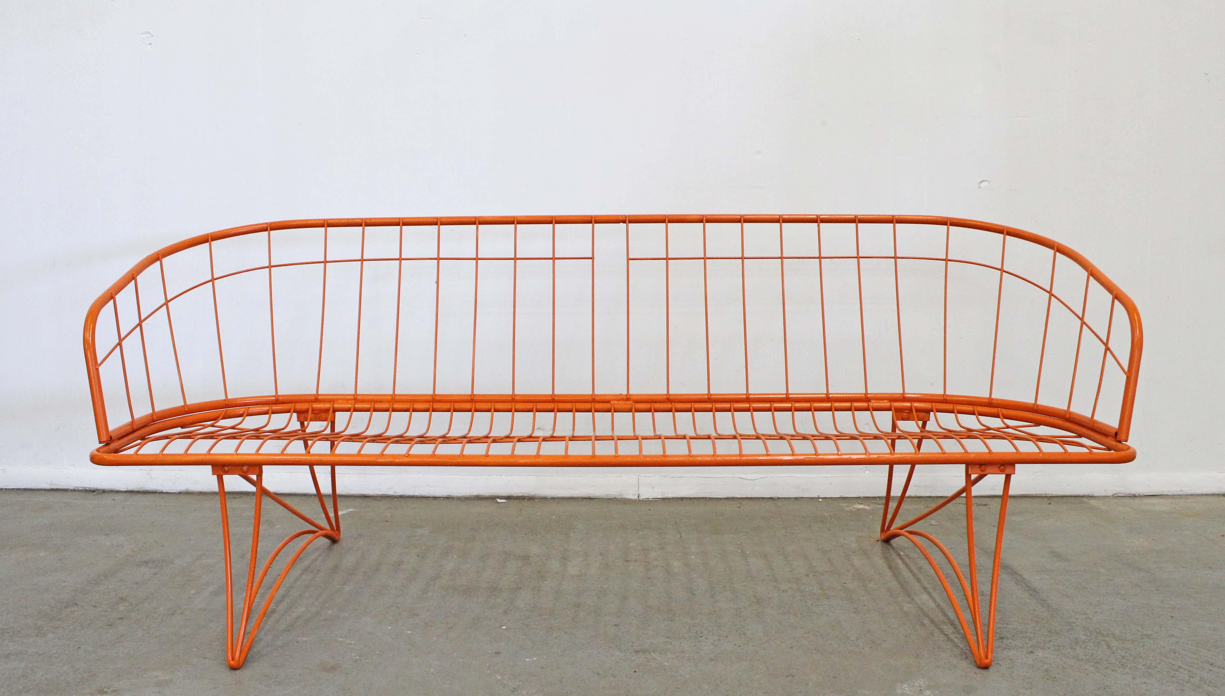 What a find. Offered is a midcentury wrought iron outdoor/patio 'Grenada' sofa made by Homecrest Bottemiller, circa 1968. This piece has been repainted in an atomic orange. It is in good condition considering its age, has new paint and includes