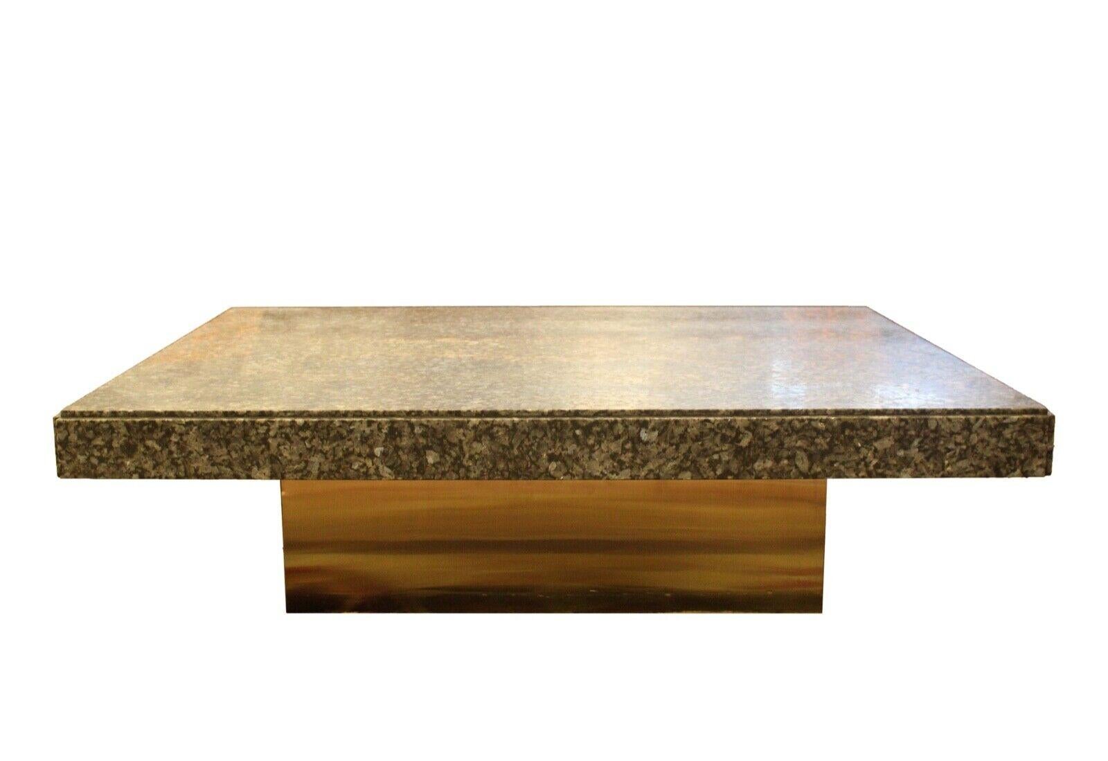 Le Shoppe Too presents this magnificent table by the famous architect Irv Tobocman. Made of honed granite floating on a brushed brass square base. In excellent condition. Dimensions: 53.25