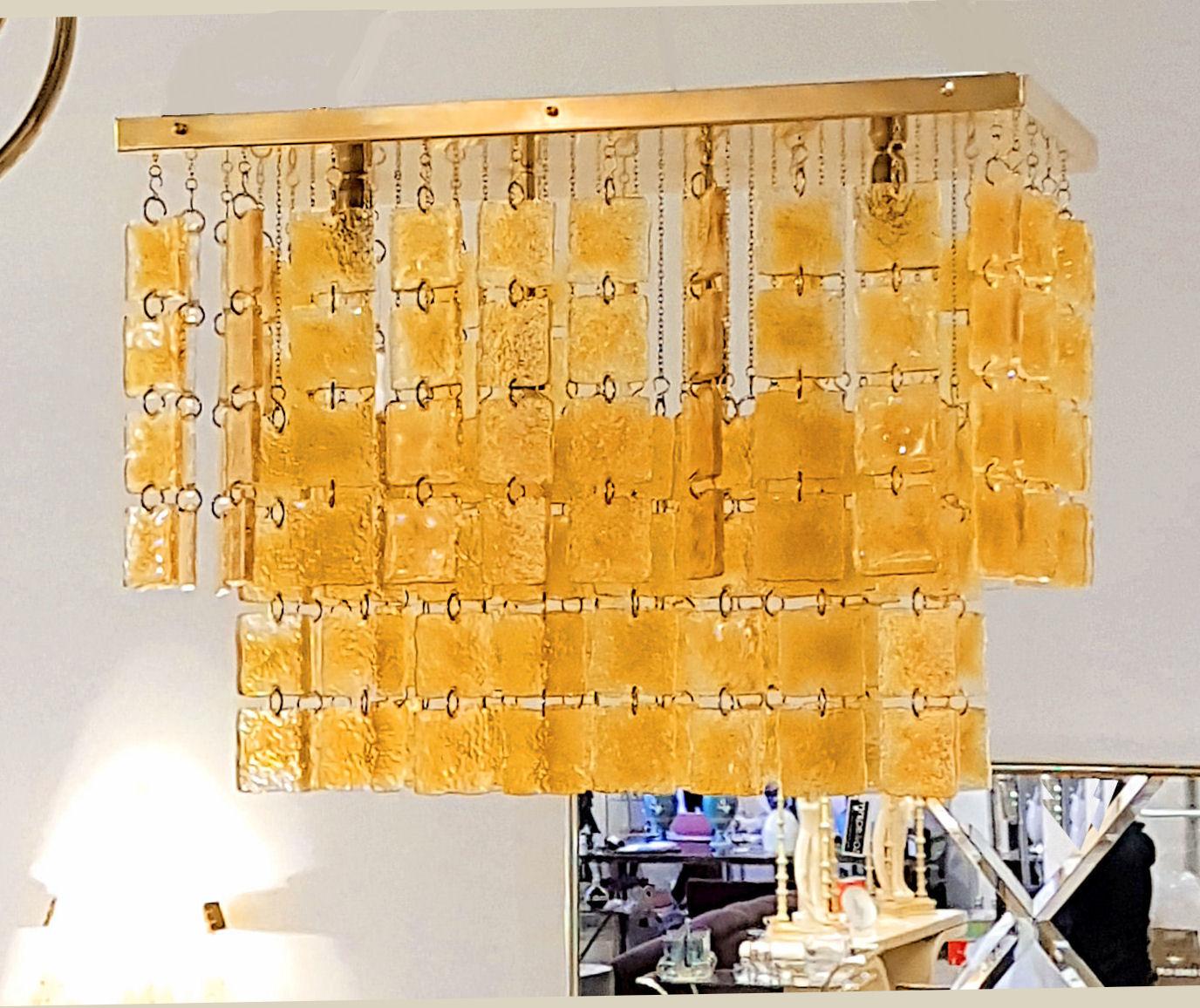 Large Mid-Century Modern Murano honey color textured squares of glass/ brass frame flush-mount ceiling light, Italy, 1970s.
Rectangular shape. Height adjustable with brass chains.
4-light, rewired for the US.
Creating a beautiful and sunny light