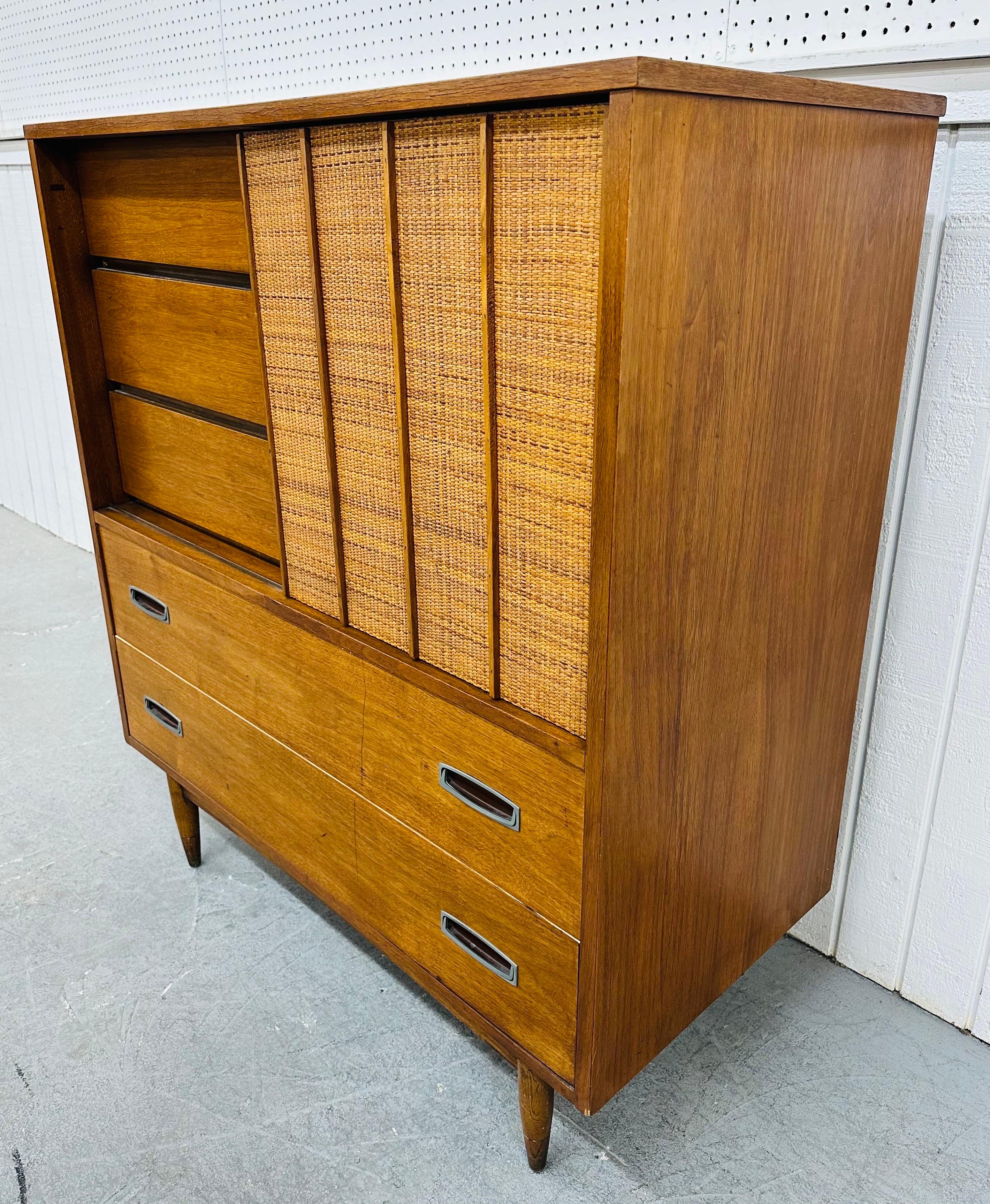 This listing is for a Mid-Century Modern Hooker Walnut & Cane High Chest. Featuring a straight line design, sliding cane door, six drawers at the top, two larger drawers at the bottom with original metal pulls, modern legs, and a beautiful walnut