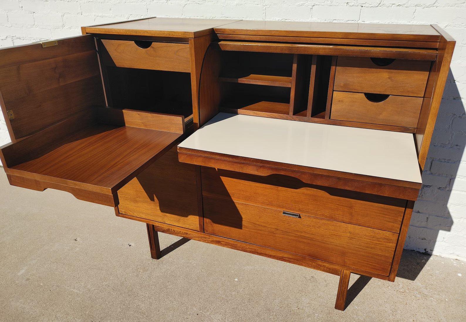 Mid Century Modern Hooker Walnut Roll Top Secretary

Above average vintage condition and structurally sound. Has some expected slight finish wear and scratching. Top has a couple areas with slight finish crinkling. Outdoor listing pictures might