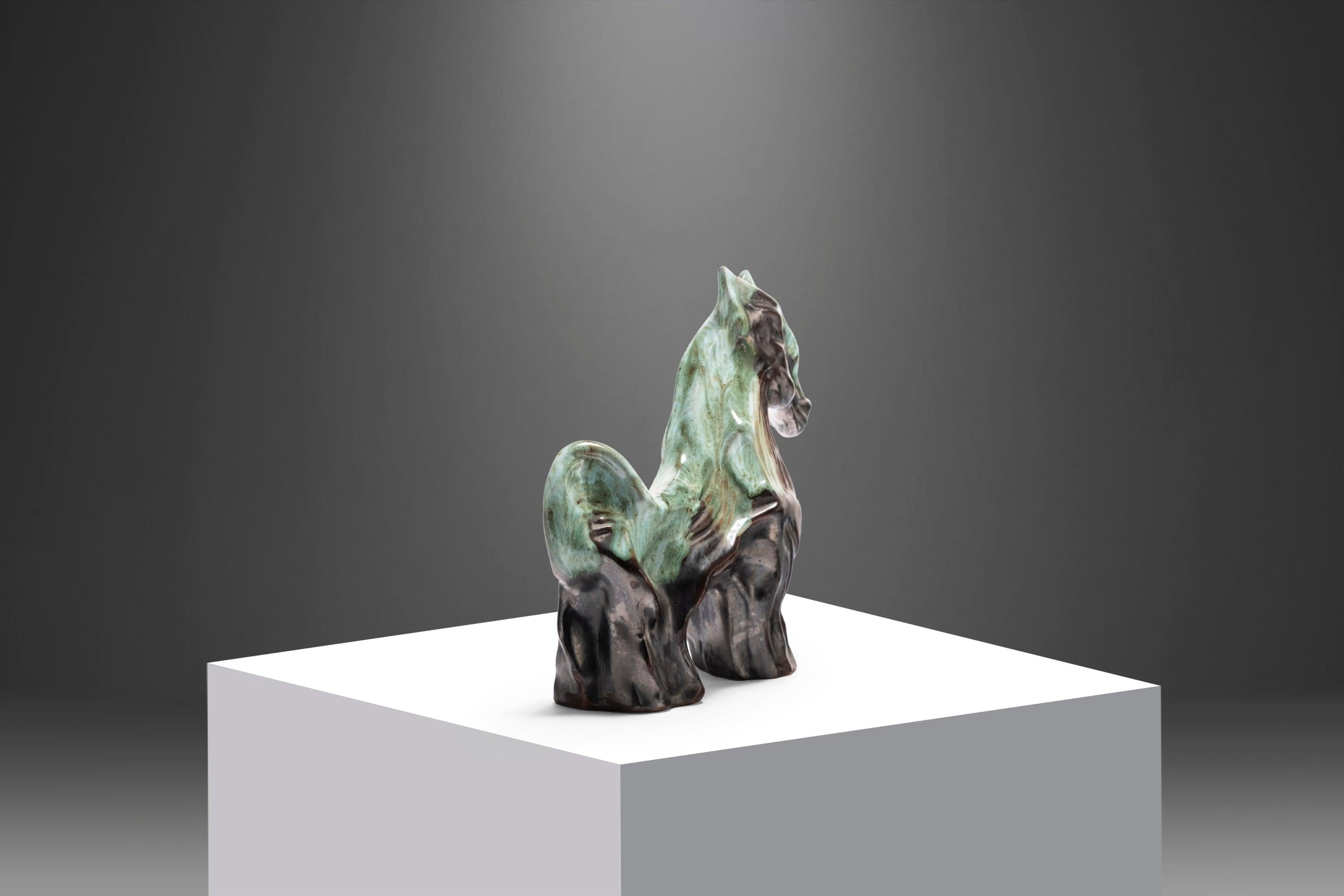A stunning sculptural decorative horse crafted from porcelain and beautifully glazed with dark shades of greens, charcoal, and black.
   