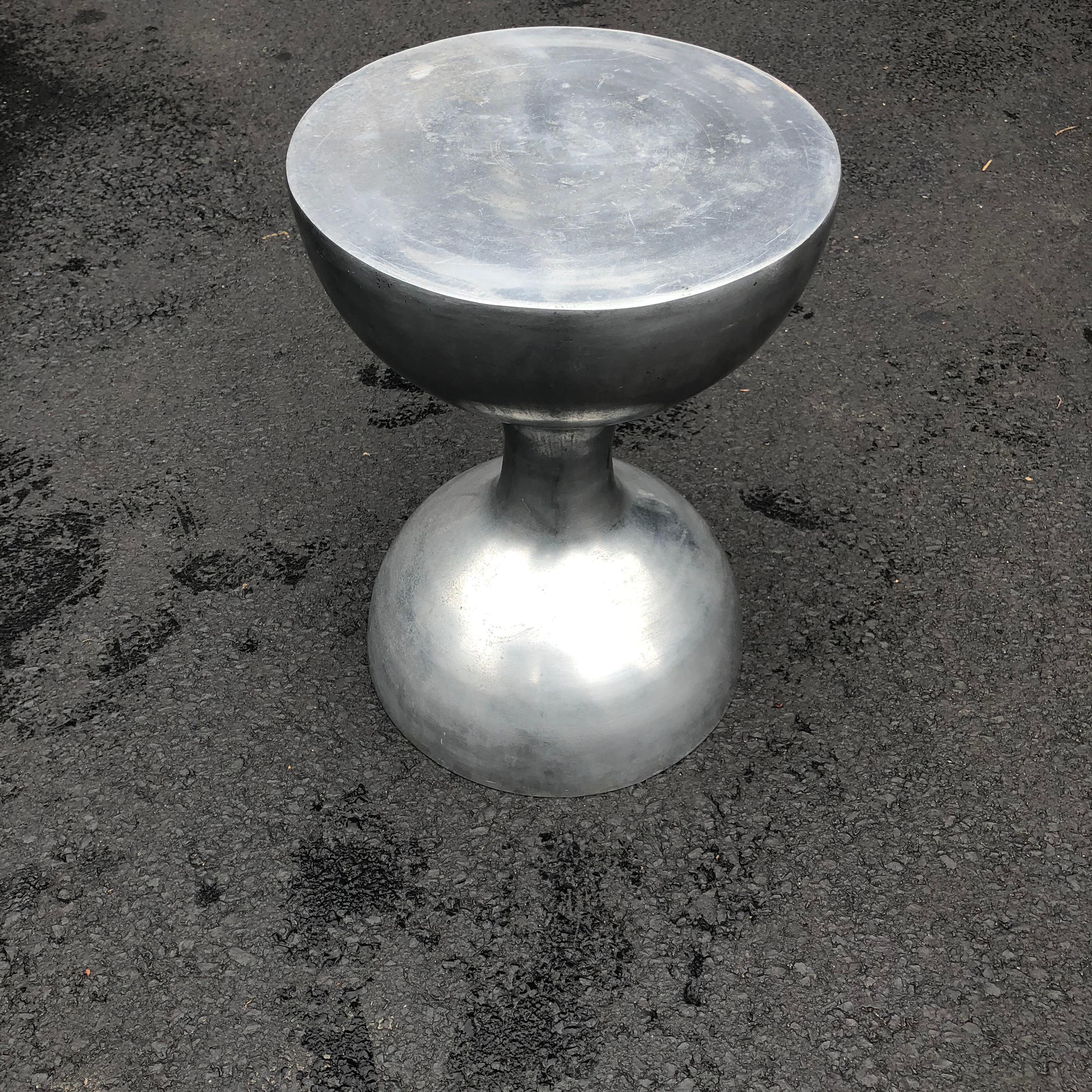Mid-Century Modern hourglass pedestal in thick aluminum plate.

3/16 inch thick aluminum plate with a rough industrial finish.