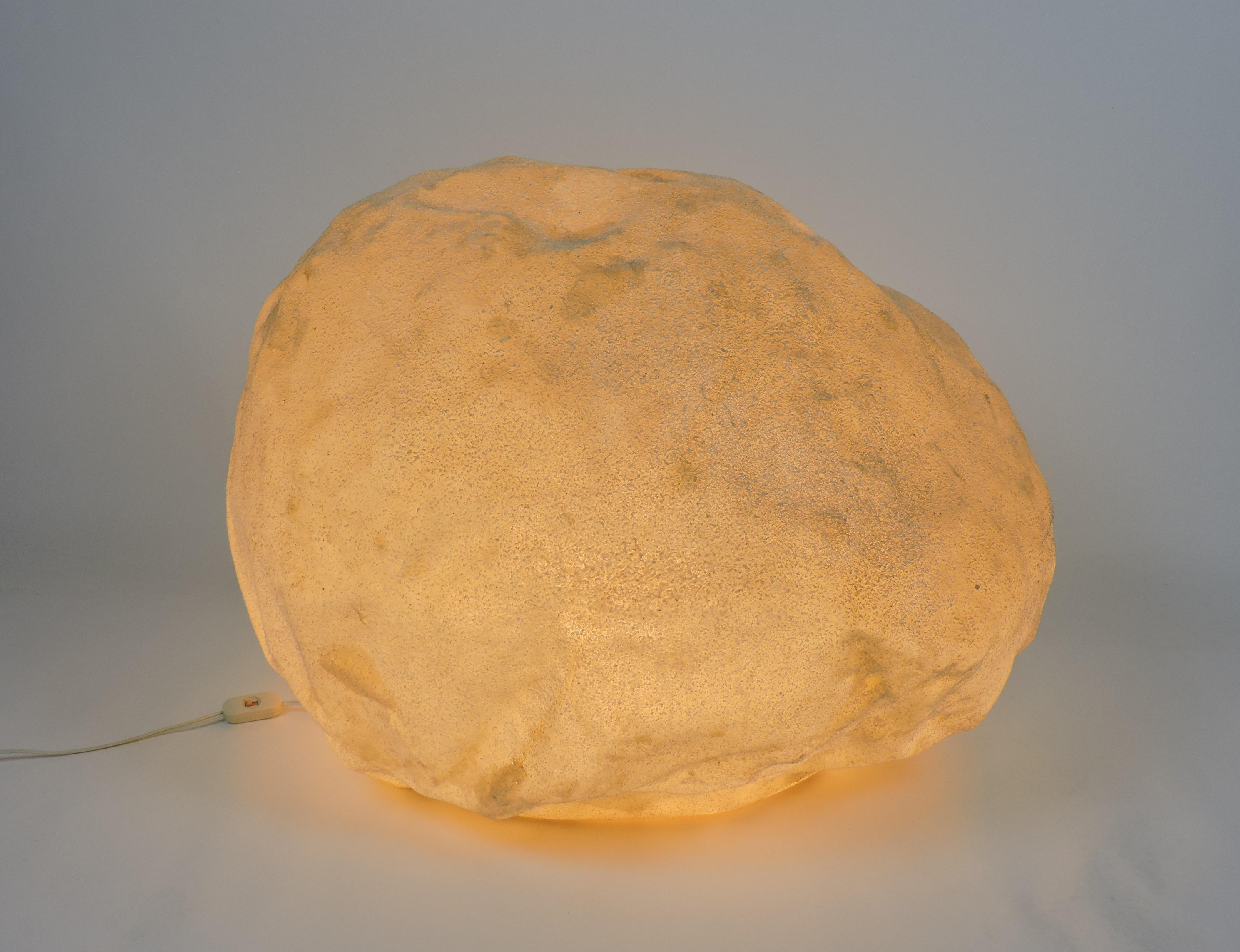 Very cool luminescent moon rock designed by Andre Cazenave and manufactured in Italy by Singleton in the 1970s. This lamp is made of translucent resin with marble powder inclusions and glows with a soft ambient light when lit. Very hard to find,