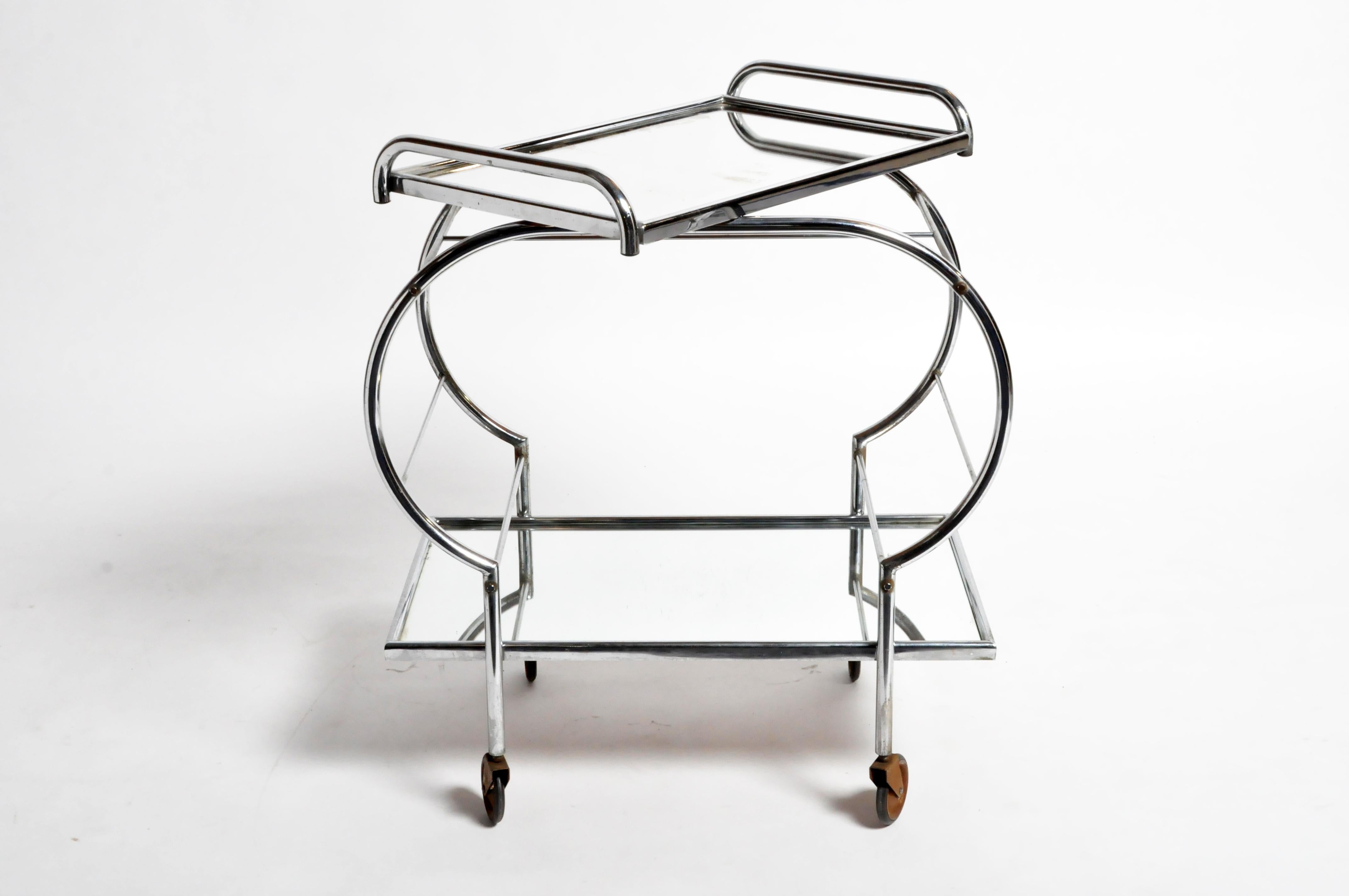 This elegant serving cart is from Hungary and was made from metal, circa 1950. The cart features a removable top tray that functions as a serving tray. Wear consistent with age and use.