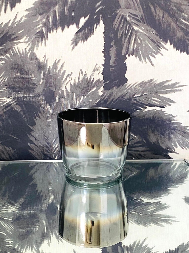 Vintage cocktail ice bucket in the style of Dorothy Thorpe. Glass ice bucket has minimalist design with ombré fade rim in hues of dark silver or gunmetal with polished edges. Makes a chic addition to any barware collection. Matching barware glasses