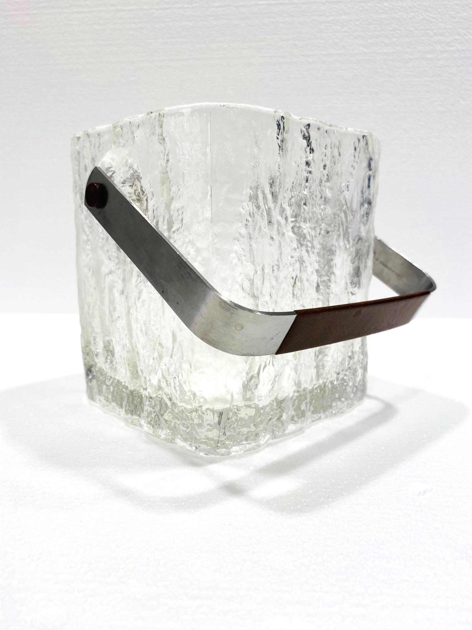 Mid-Century Modern glass ice bucket with textured ice cube design. Vintage Japanese personal size ice bucket comprised of thick chunky glass with polished edges and translucent base. Features a stainless steel handle wrapped in brown stitched