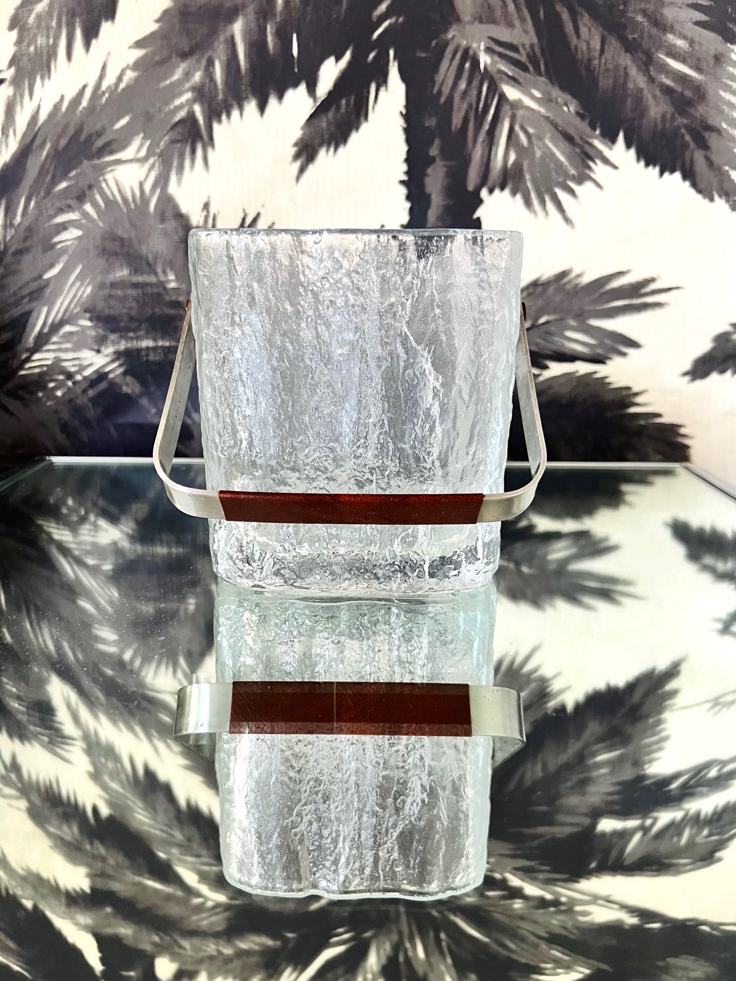 Mid-Century Modern Japanese personal size ice bucket comprised of thick chunky glass with polished edges and translucent base. The vintage bucket has a textured ice cube design and features a stainless steel handle wrapped in brown stitched