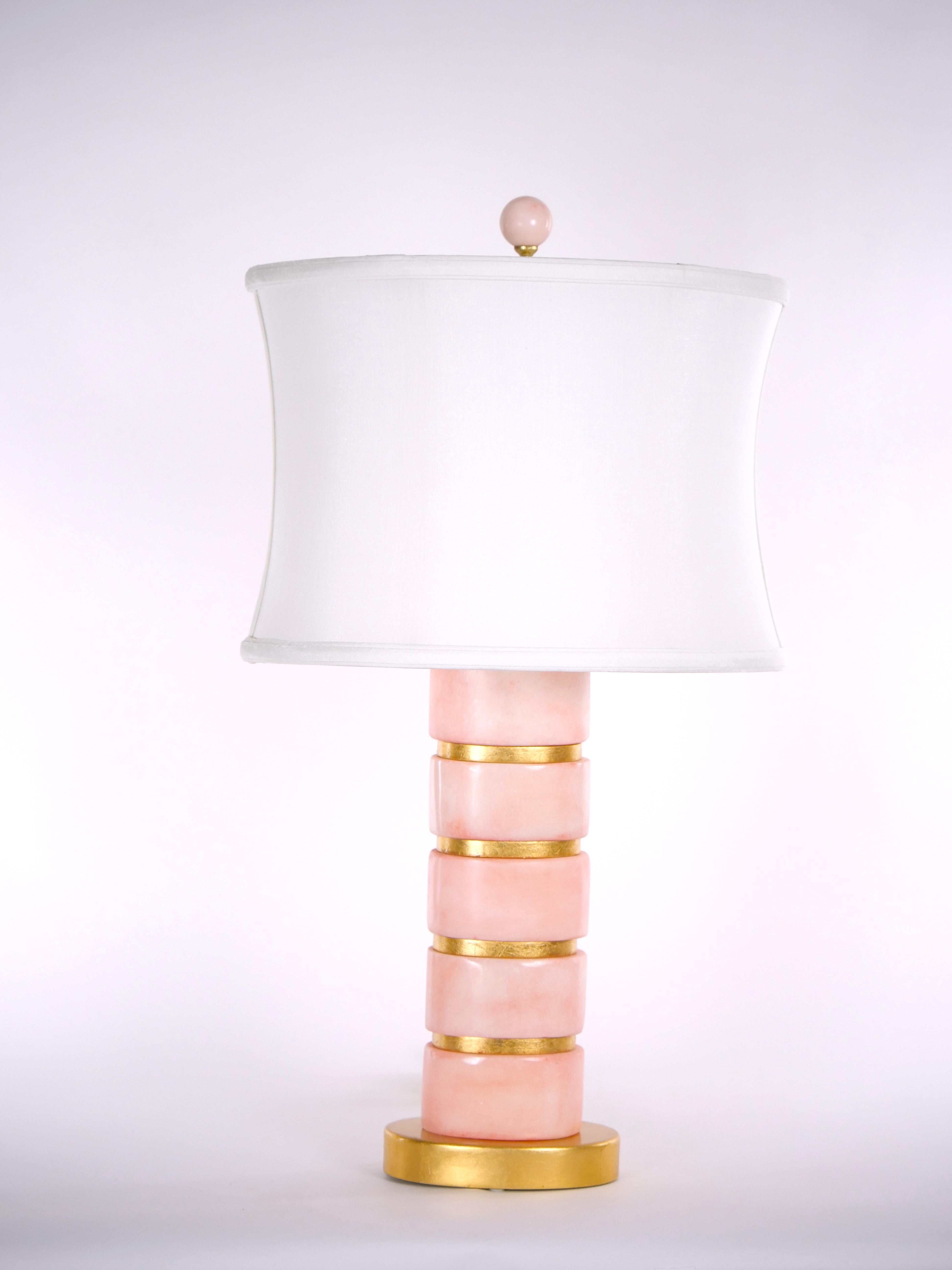 Mid-Century Modern pair ice pink color jade and gilt gold wood decorated design pair table lamp. Each lamp features an Art Deco architectural look with clean line and color very pleasing and smoothing to the naked eye all resting on an oval gilt