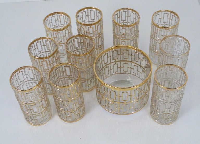 A stunning set of 10 mid-century gilt trim highball glasses and matching ice bucket by the Imperial Glass Company in a pattern named Shoji Screen. Each piece is molded with a raised pattern inspired by Japanese Shoji screens, the raised areas are