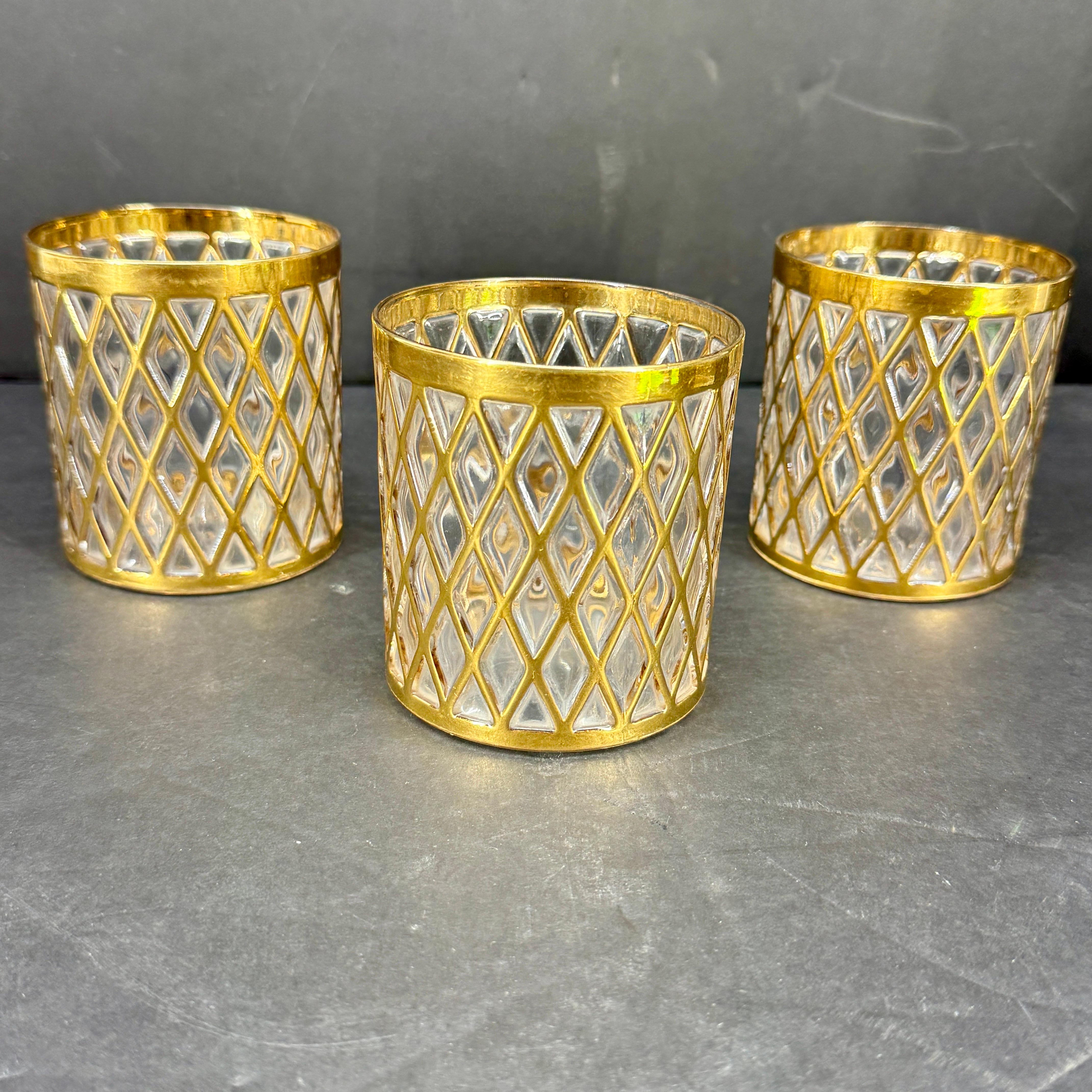 Rare diamond pattern 22K gold hand painted barware from the iconic the Imperial Glass Company, circa 1970's. The set includes three whiskey glasses. These glasses are highly sought after in this classic diamond pattern and raised texture. This set