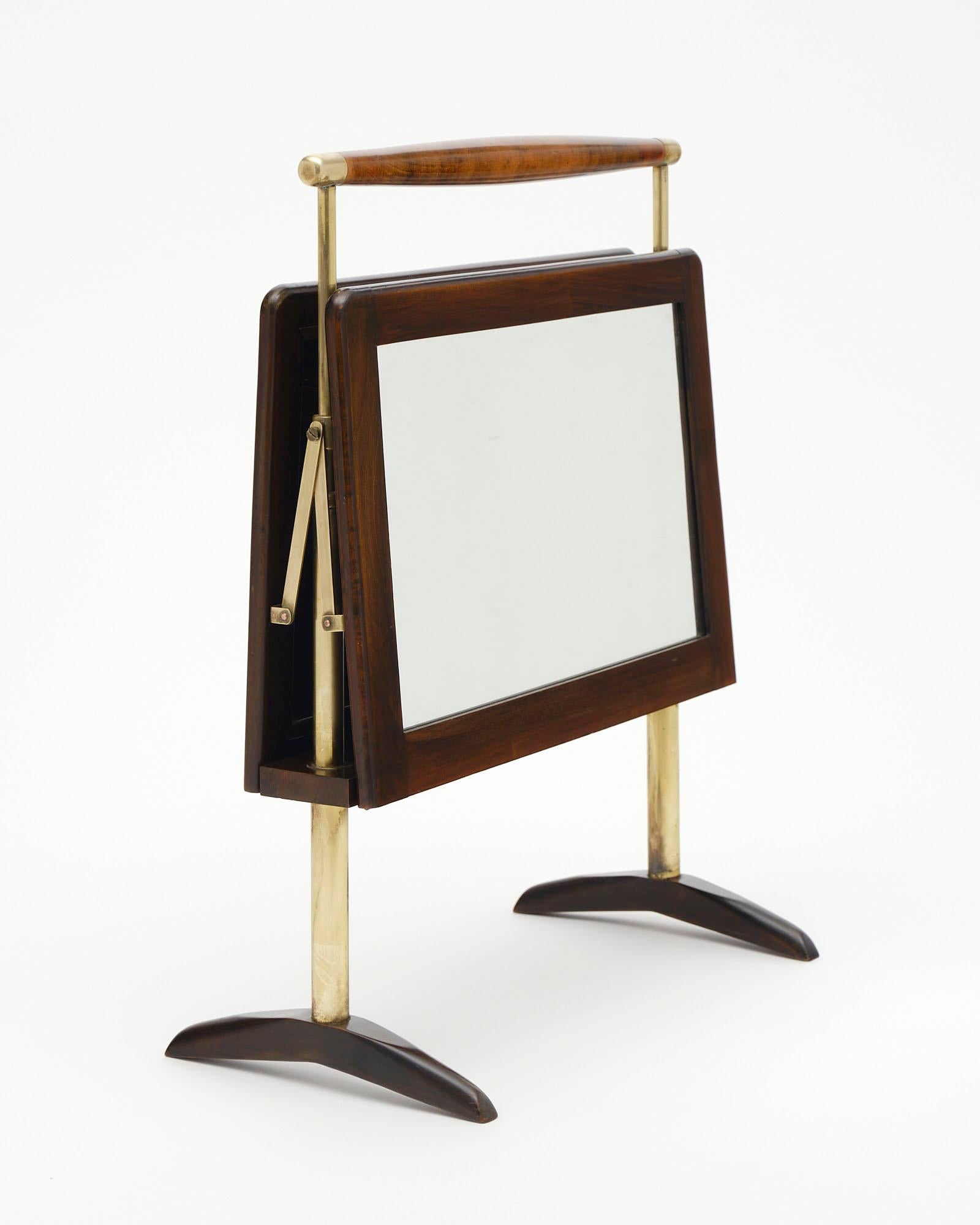 Italian magazine stand; from Verona. This unique piece is made of rosewood and brass with mirrored panels on both sides. This sleek design was inspired by the Ico Parisi was an Italian architect and designer Ico Parisi.

Dimensions are with the