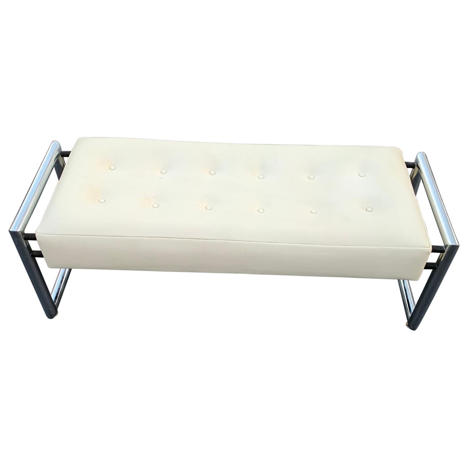 Mid-Century Modern industrial chrome bench with original white vinyl upholstery
bench has tubular chrome legs. Fabric is the original white vinyl with some discoloration. New upholstery is recommended.