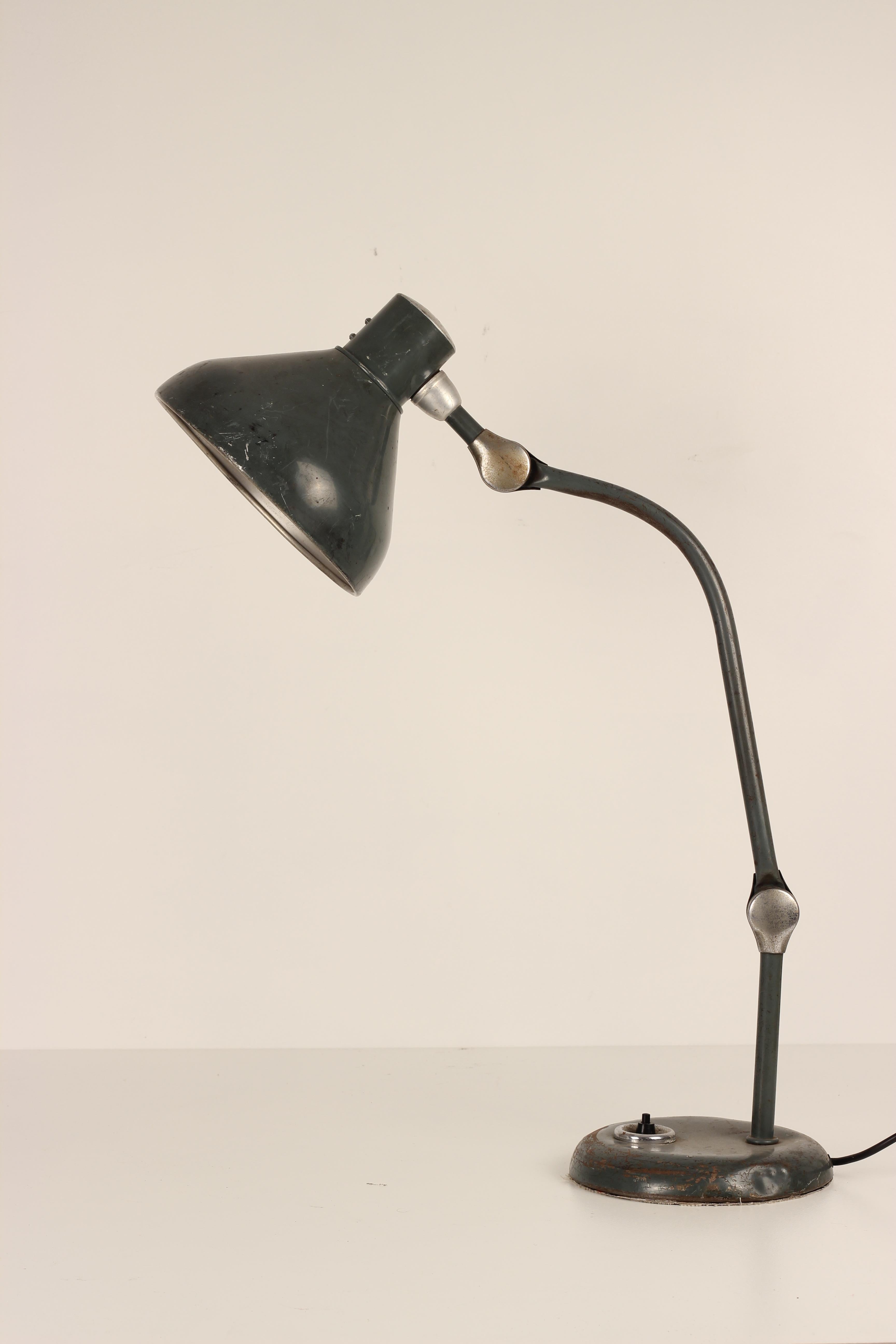 A mid century Industrial desk lamp, which has age related wear but still retains its original paint finish. Fully adjustable to many positions as shown in the images, the light makes for a very practical solution for a flexible work light. Sourced