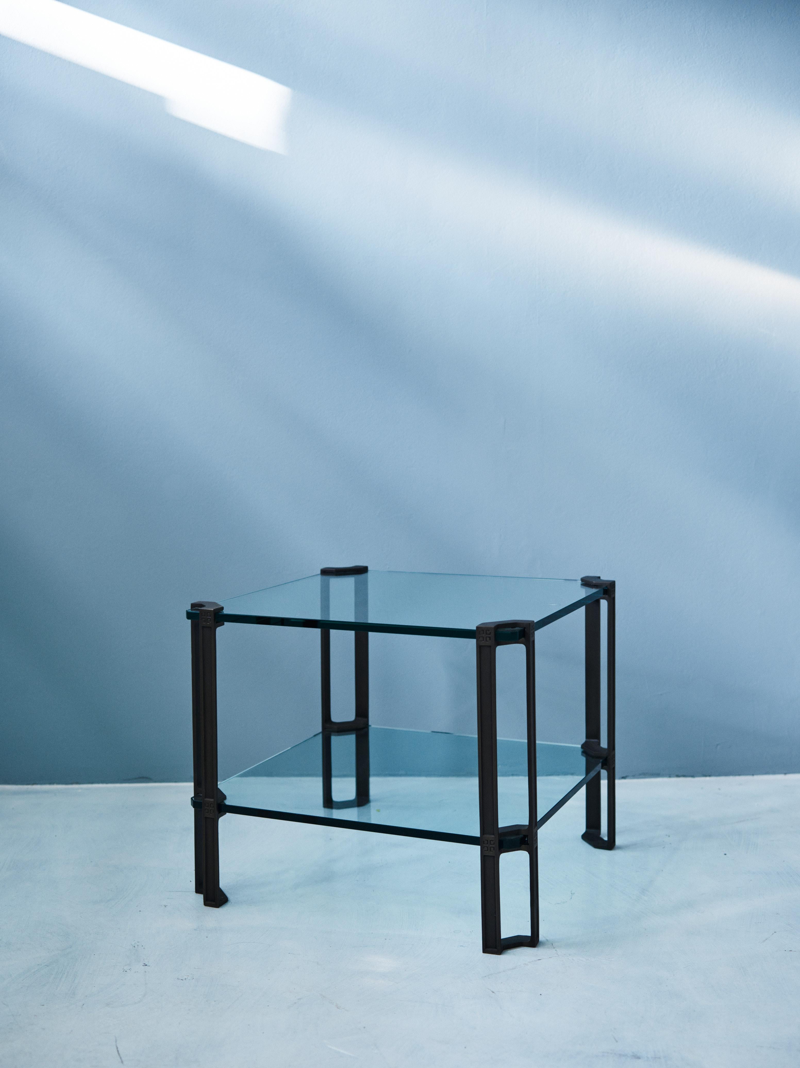 This mid-century modern glass table with casted brass framing was designed by Peter Ghyczy in 1976 and hand-made in the GHYCZY atelier in the South of the Netherlands. The table features Peter Ghyczy's 1973 trademarked casting and clamping