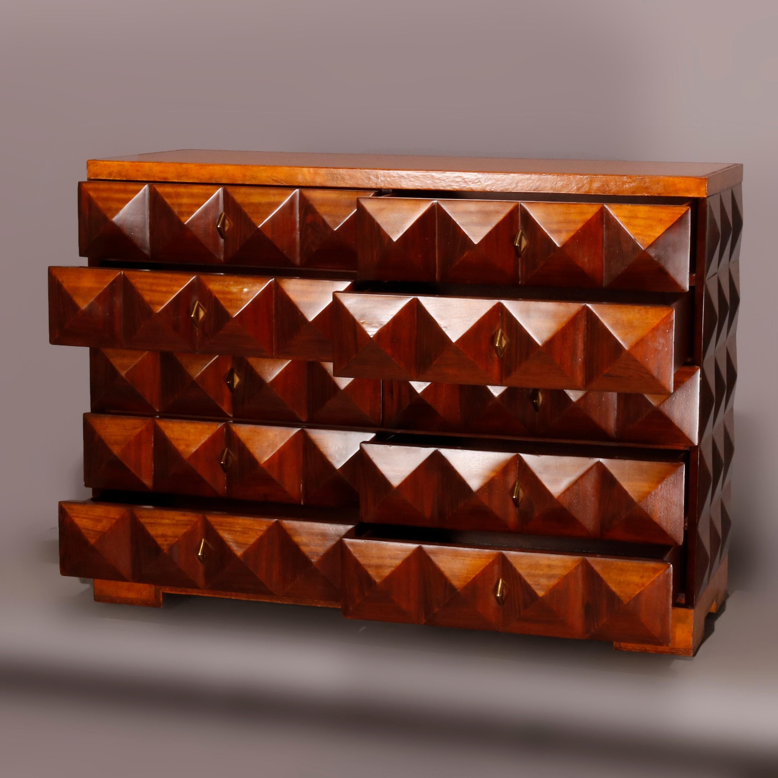 A Mid-Century Modern chest by Maitland Smith offers mahogany construction with repeating pattern of faceted geometric pyramid studs throughout and ten drawers, en verso and drawer maker labels, mid-20th century.

Measures: 33.5
