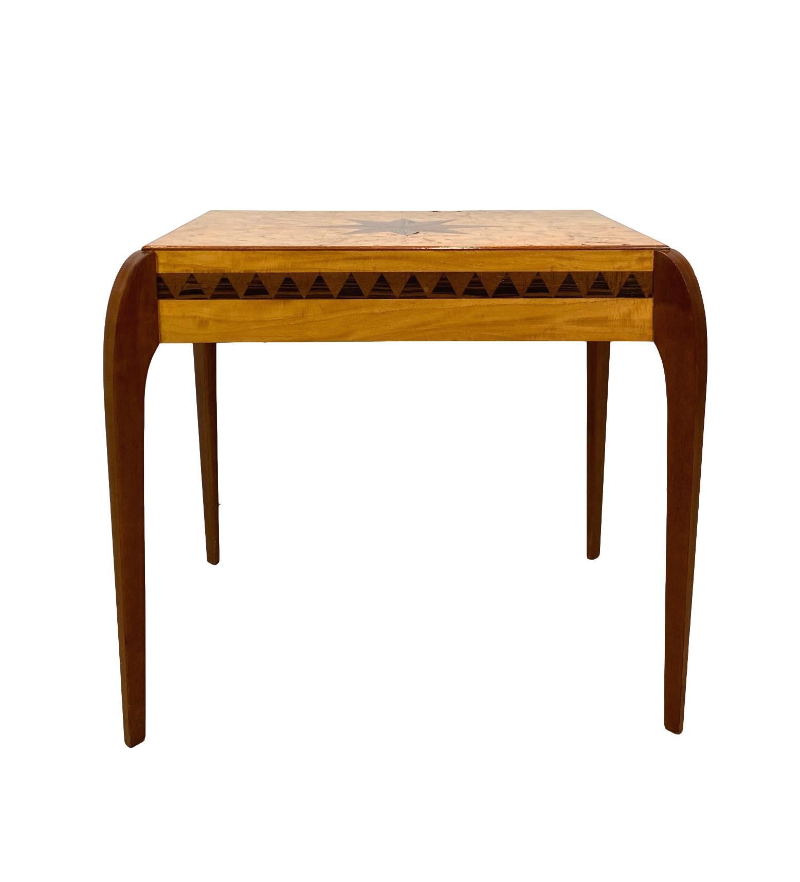 Mid-Century Modern/Art Deco-style inlaid center table in exotic woods, the thick cut parquetry burl maple top with a large inlaid rosewood trompe l'oeil compass star, all four sides with an inlaid geometrical band of alternating rosewood and