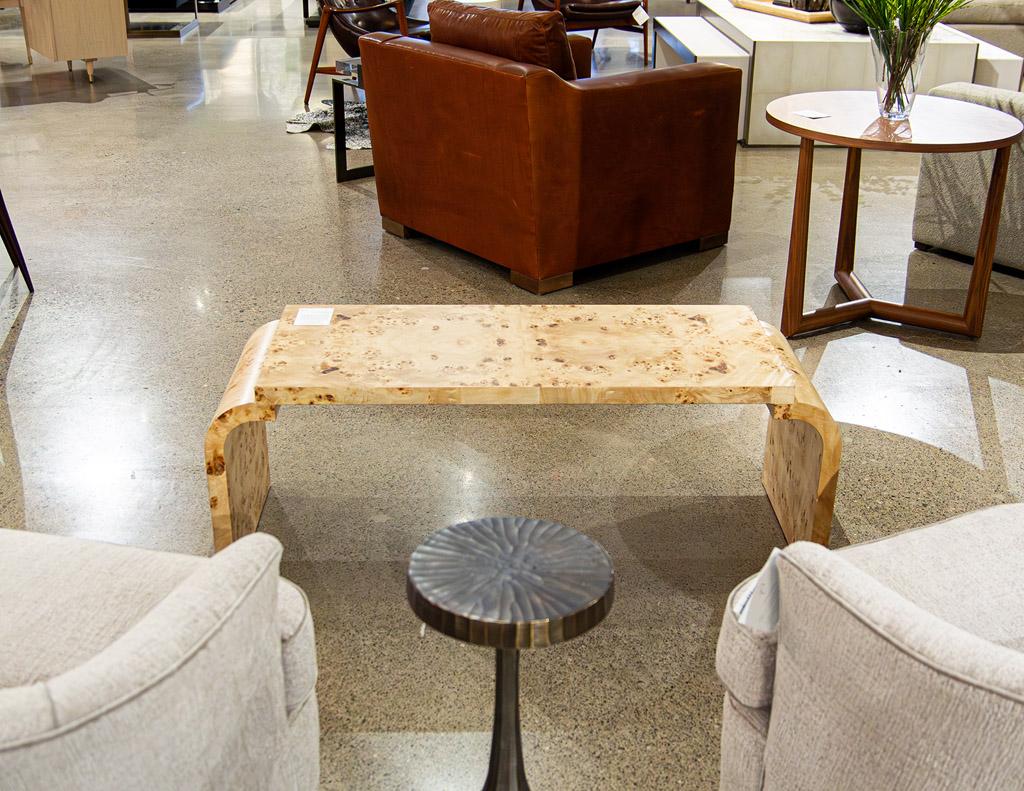 This stunning piece is proudly made in the USA, crafted with the utmost care and attention to detail. The coffee table is constructed from high-quality burl walnut wood, known for its beautiful and unique grain patterns. The natural light walnut