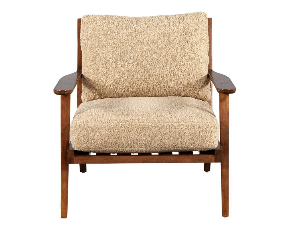Mid-Century Modern inspired maple lounge chair by Ellen Degeneres Mildas Chair. Featuring beautiful maple wood frame. Completed with thick plush cushions for maximum comfort. Finished in a satin dark brown maple with textured dark beige fabric.