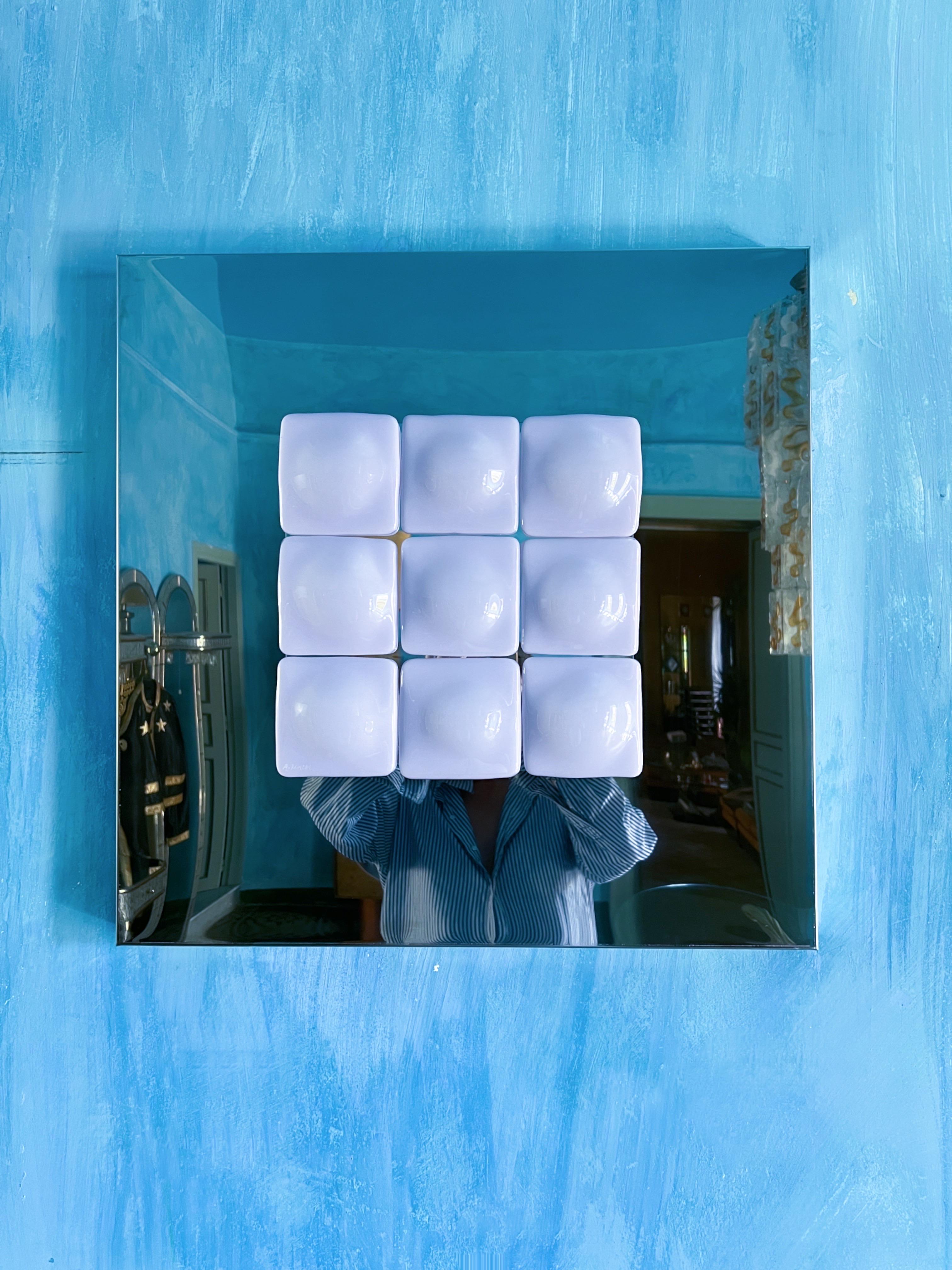 Mirror Illusion
A stunning art piece designed by Swedish artist Amanda Malm.

This captivating sculpture blends stainless steel and fused glass in a light pink tone. Nine nearly symmetrical square glass pieces, each softened by a round, feminine