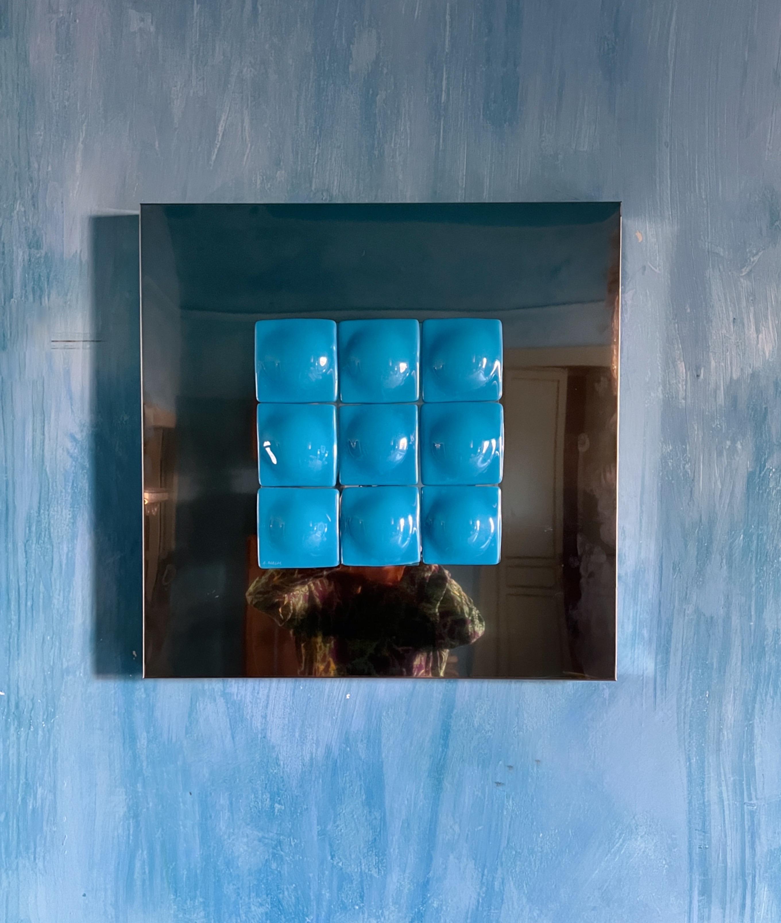 Mirror Illusion
A stunning art piece designed by Swedish artist Amanda Malm.

This captivating sculpture blends stainless steel and fused glass in a radiant light blue tone. Nine nearly symmetrical square glass pieces, each softened by a round,