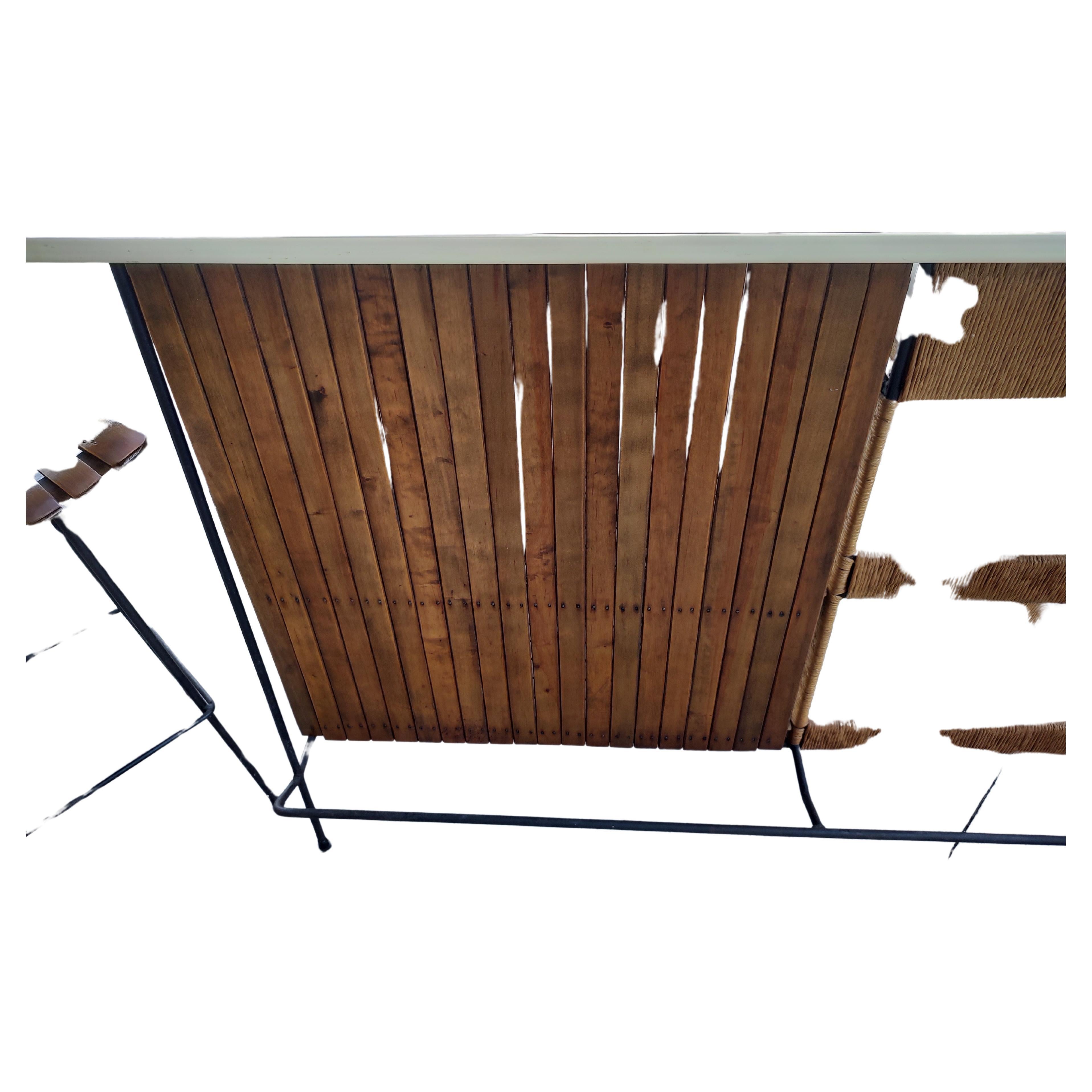 Fabulous Arthur Umanoff 4 PC set which includes the large, 60 inch bar with shelving and 3 original bar stools. This set is in great original condition with no issues at all. Wood, Raffia and iron all in exceptional condition. We have other bar