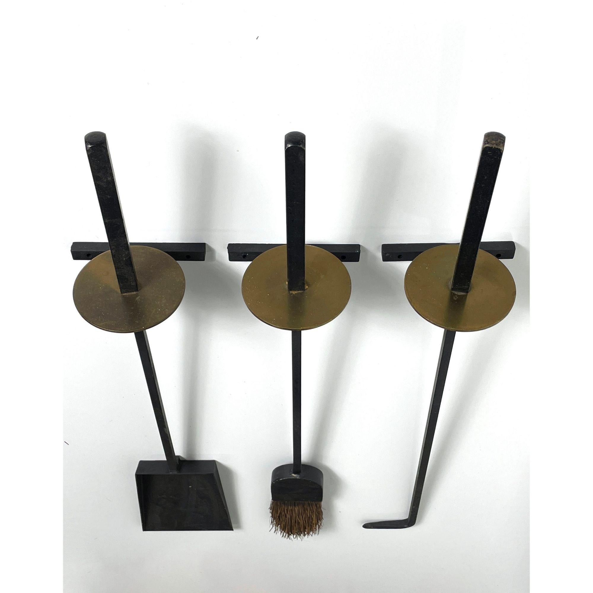 Vintage Mel Bogart Iron Brass Wall Mounted Fireplace Tool Set 

Set of wall mounted modernist fireplace tools designed by Mel Bogart 1951
Manufactured by Stewart Winthrop and selected by Good Design
Iron and brass shovel brush and poker

Additional