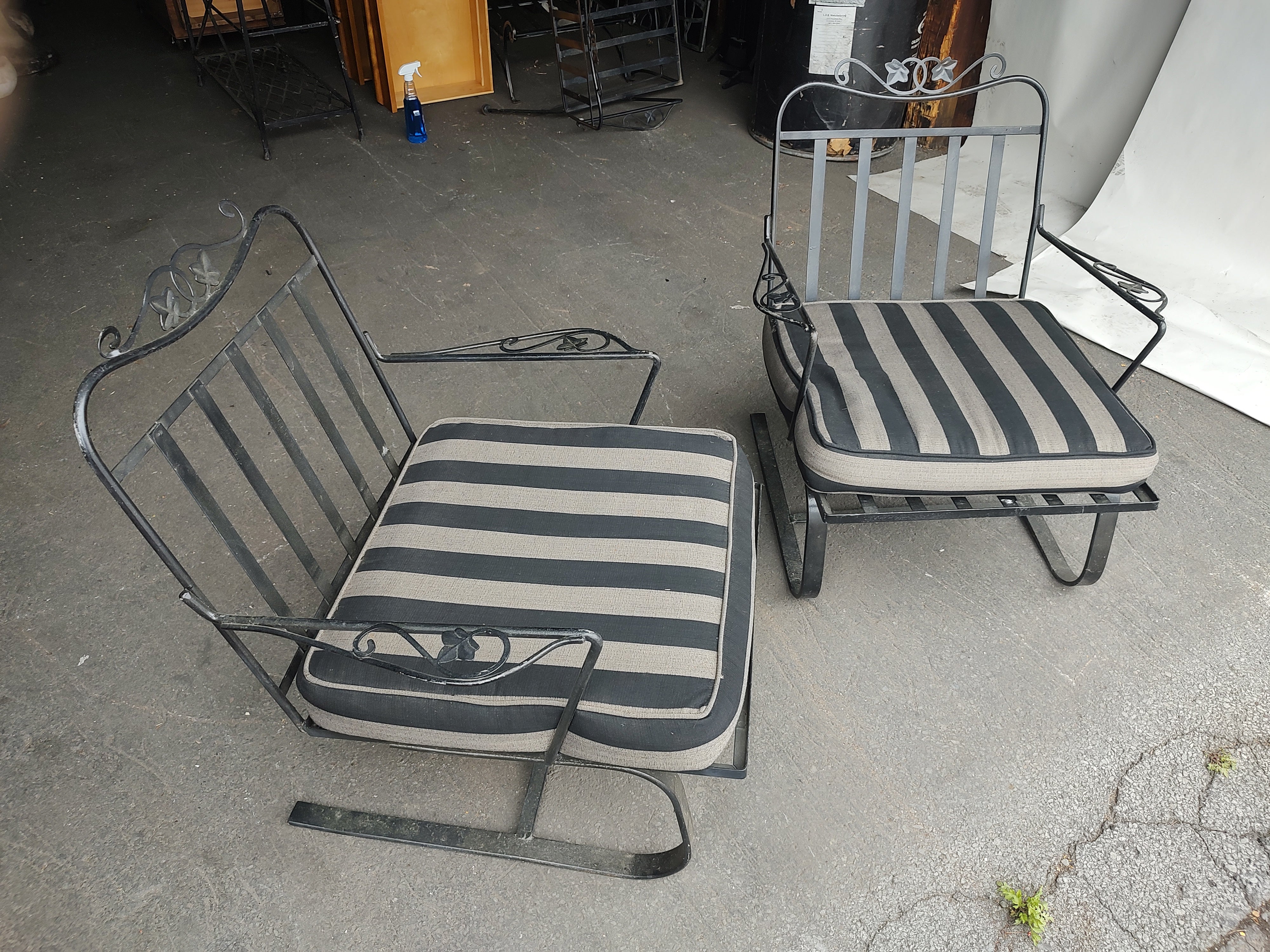 Fabulous pair of very comfy spring steel lounge armchairs by John Salterini. Full cushions in a striped silver & black outdoor fabric. Arched back for comfort with style. Iron & steel painted black and in very good vintage condition with minimal