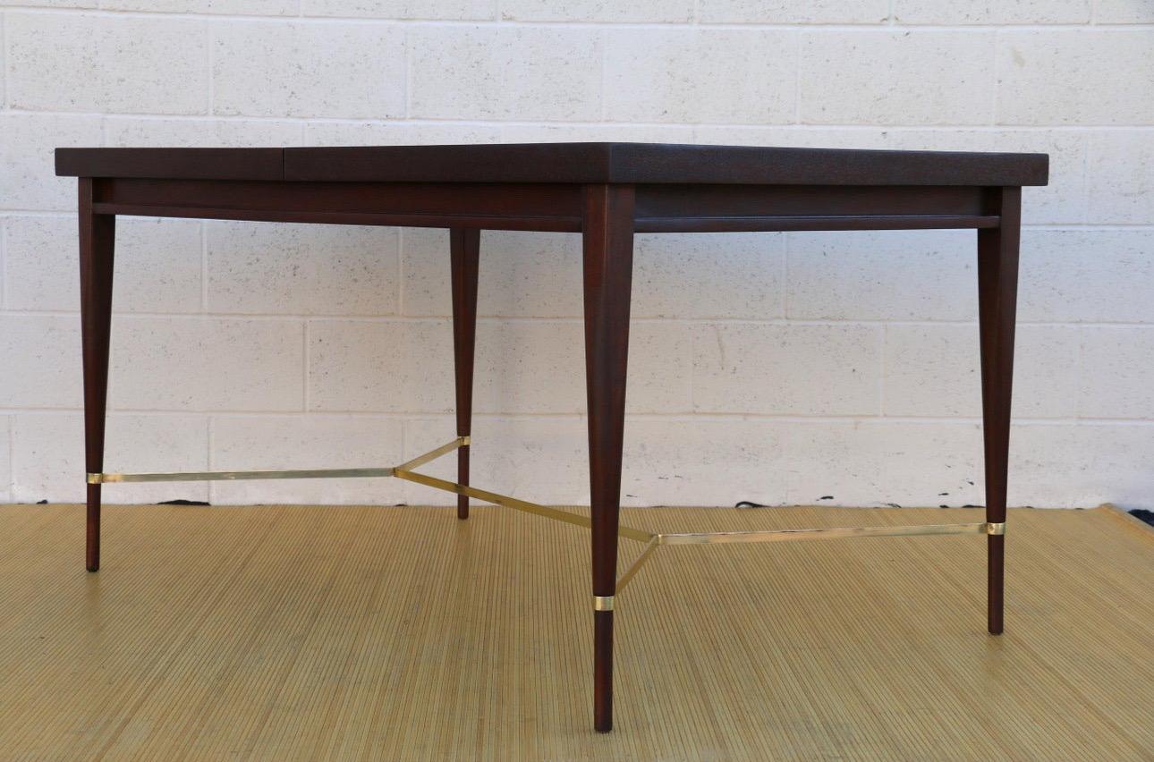 Spectacular Mid-Century Modern 1950’s dining table made of mahogany and brass details. It was designed by Paul McCobb and produced by Calvin for the 
