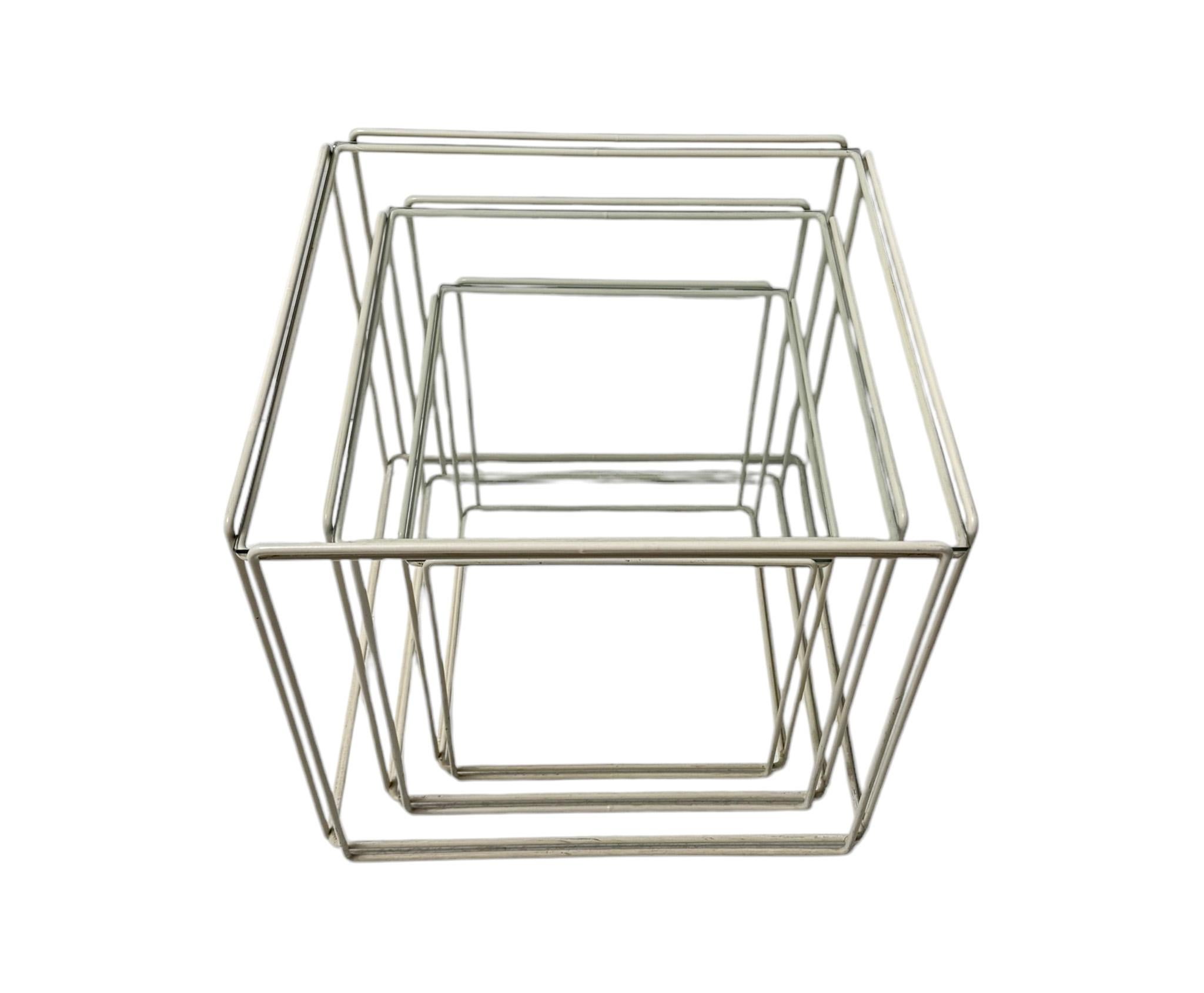 Minimalist and elegant set of three original nesting tables.Design by Max Sauze for Groupe S.A. France.Striking French design from the 1970s.Thin white enameled steel frames with  inset original glass tops.This wonderful set of three Mid-Century