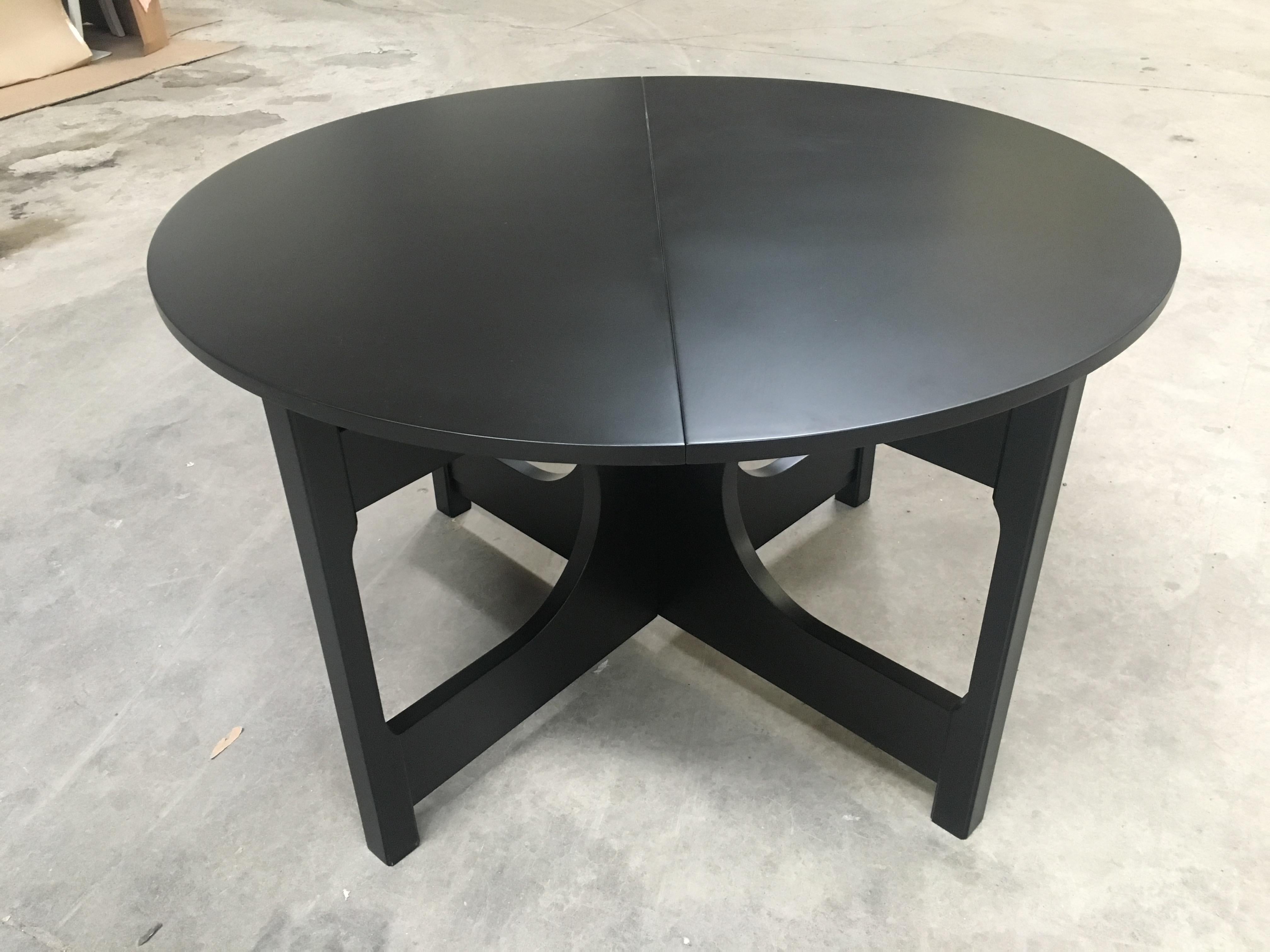 Mid-Century Modern Italian adjustable black lacquered wood dining table. 1970s
When closed the table measures cm.118 x 118 x H.74
When opened the table measures cm.118 x 158 x H.74.
 