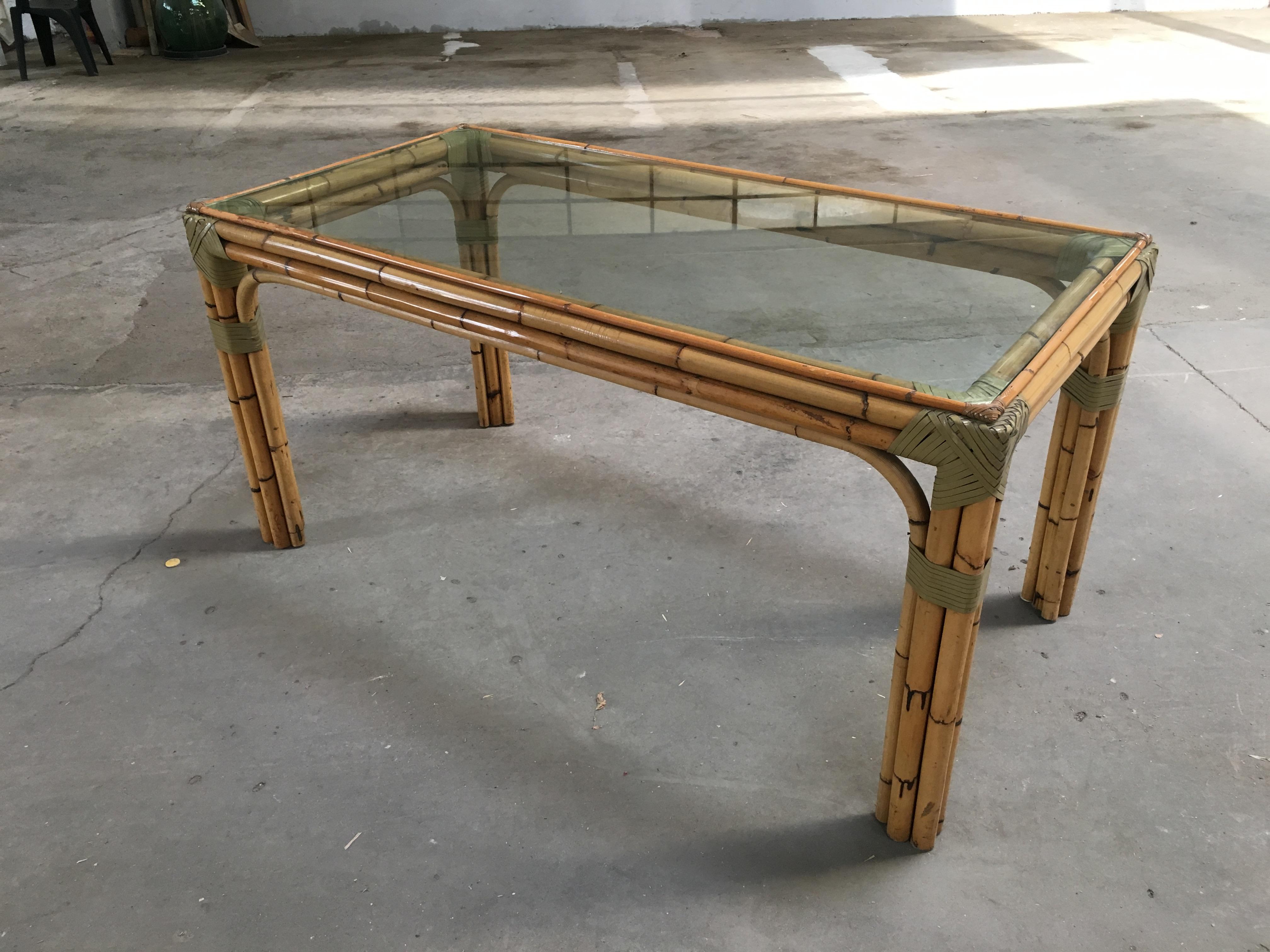 Mid-Century Modern bamboo and glass Italian dining table.
All the binding of the table are made with leather laces.
The table can become a set with its four Bamboo chairs as shown in the picture. Price for the set on request.
 
