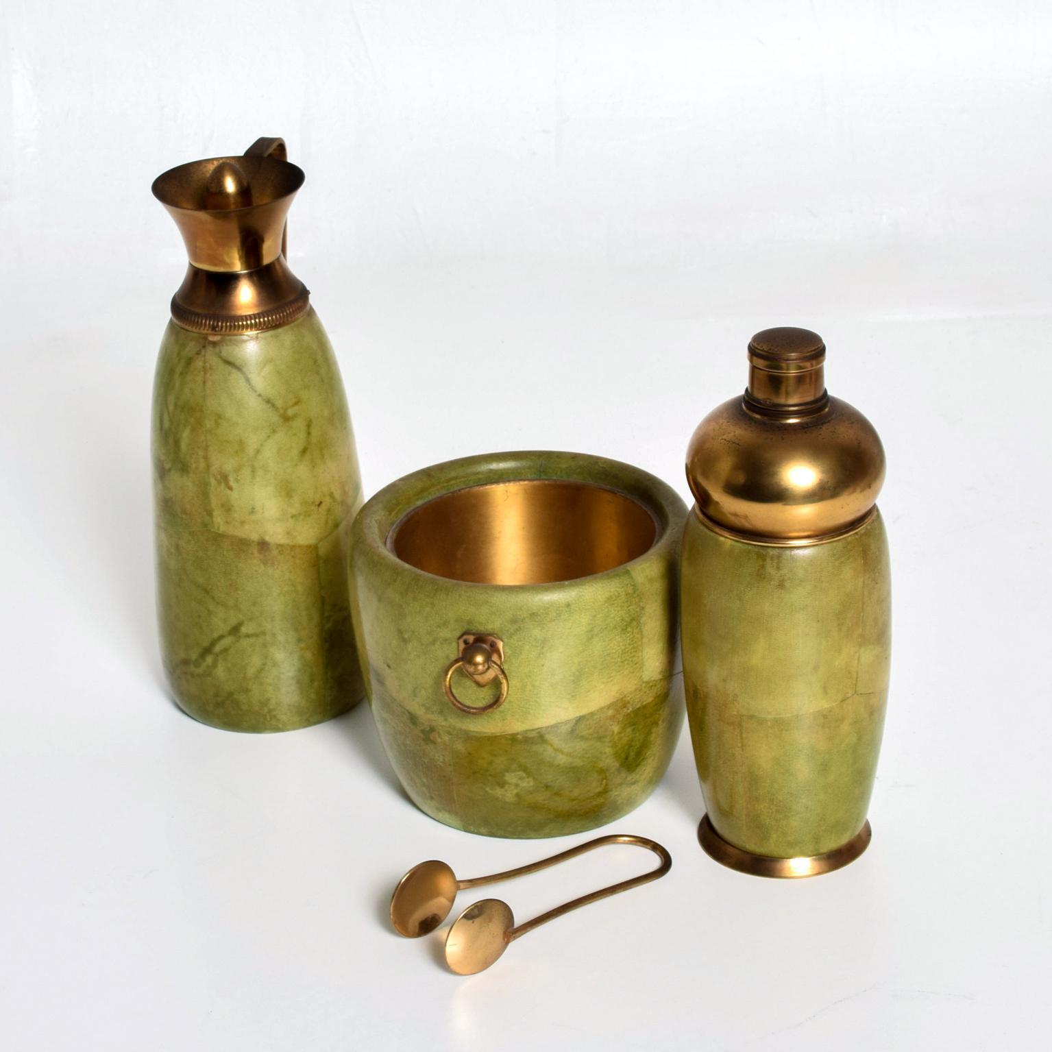 We are pleased to offer for your consideration a beautiful bar set designed by Aldo Tura for MACABO. Made in Italy circa the 1950s. Solid wood wrapped in goatskin. Original finish in amazing light green color. Brass accents with original vintage